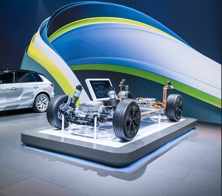 IAA Summit 2023 - Die zukünftige Audi Q6 e-tron Baureihe ist die erste auf Basis der neuen Premium Platform Electric (PPE). Im Hintergrund: der getarnte Prototyp des Audi Q6 e-tron