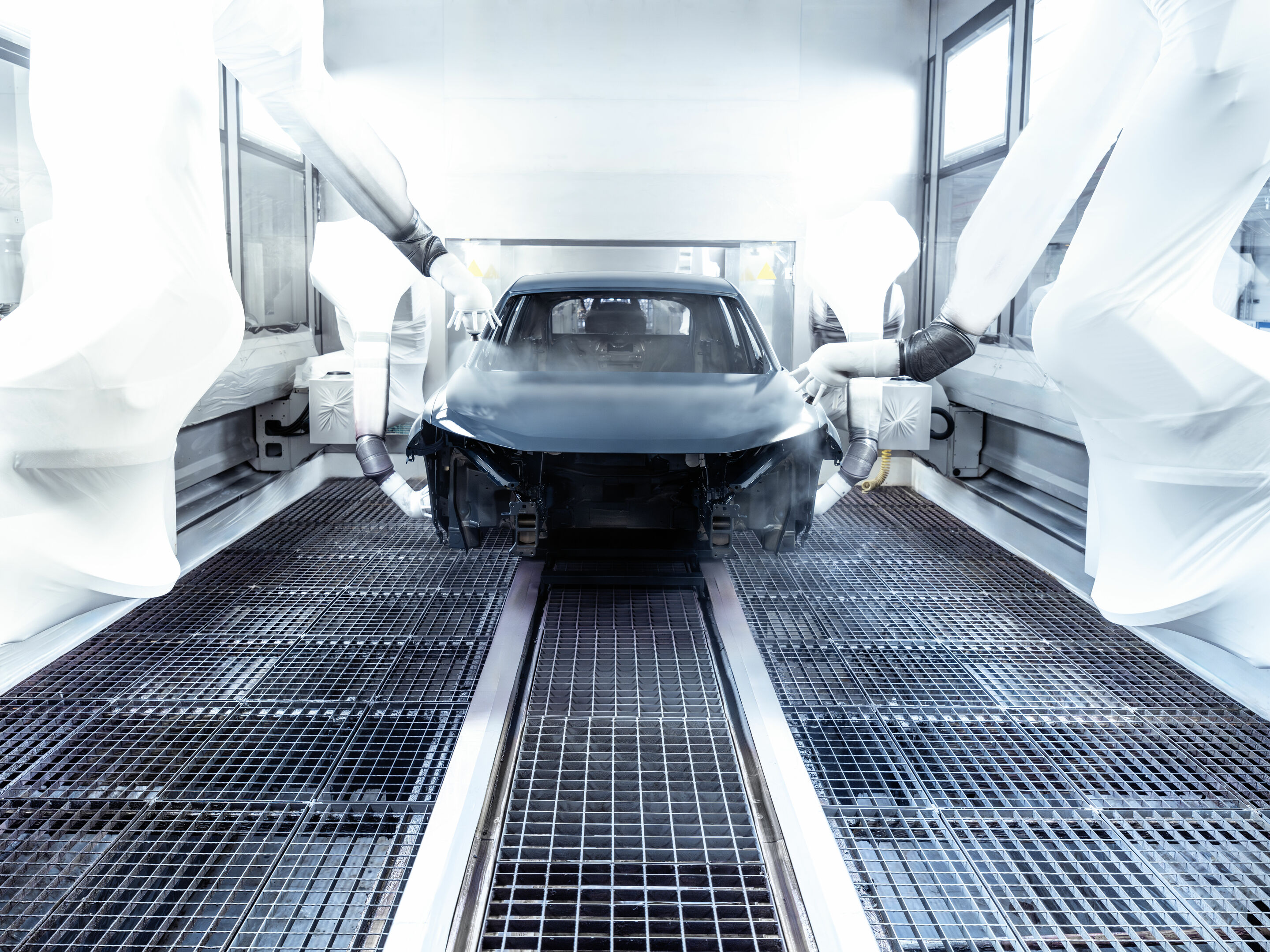 Production Audi Q6 e-tron at the Ingolstadt site - Robots spray top coat onto the outside of the bodywork.