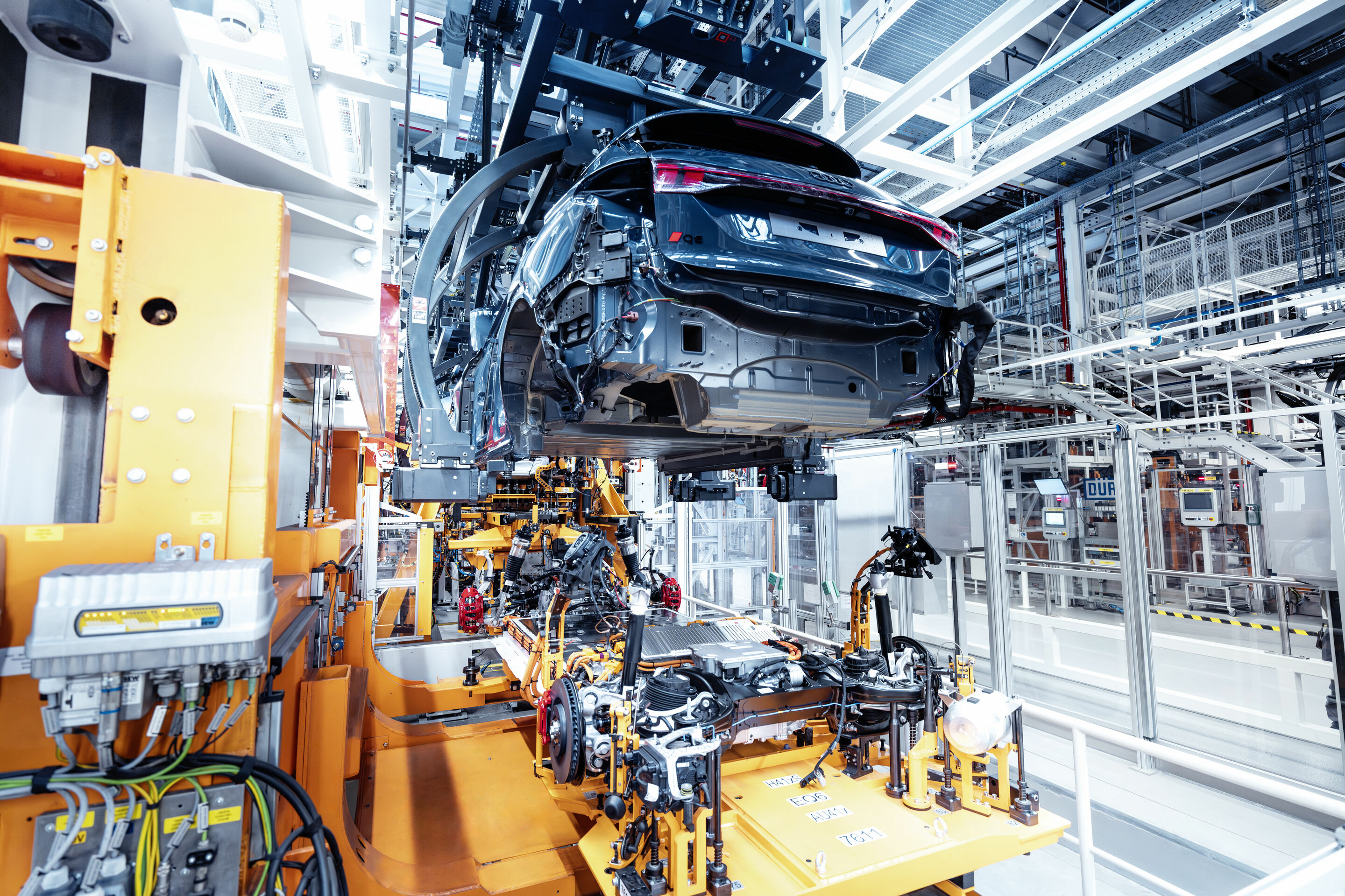 Production Audi Q6 e-tron at the Ingolstadt site - The highlight of vehicle production - the floor assembly and the body are combined during the “Hochzeit” (“marriage”).