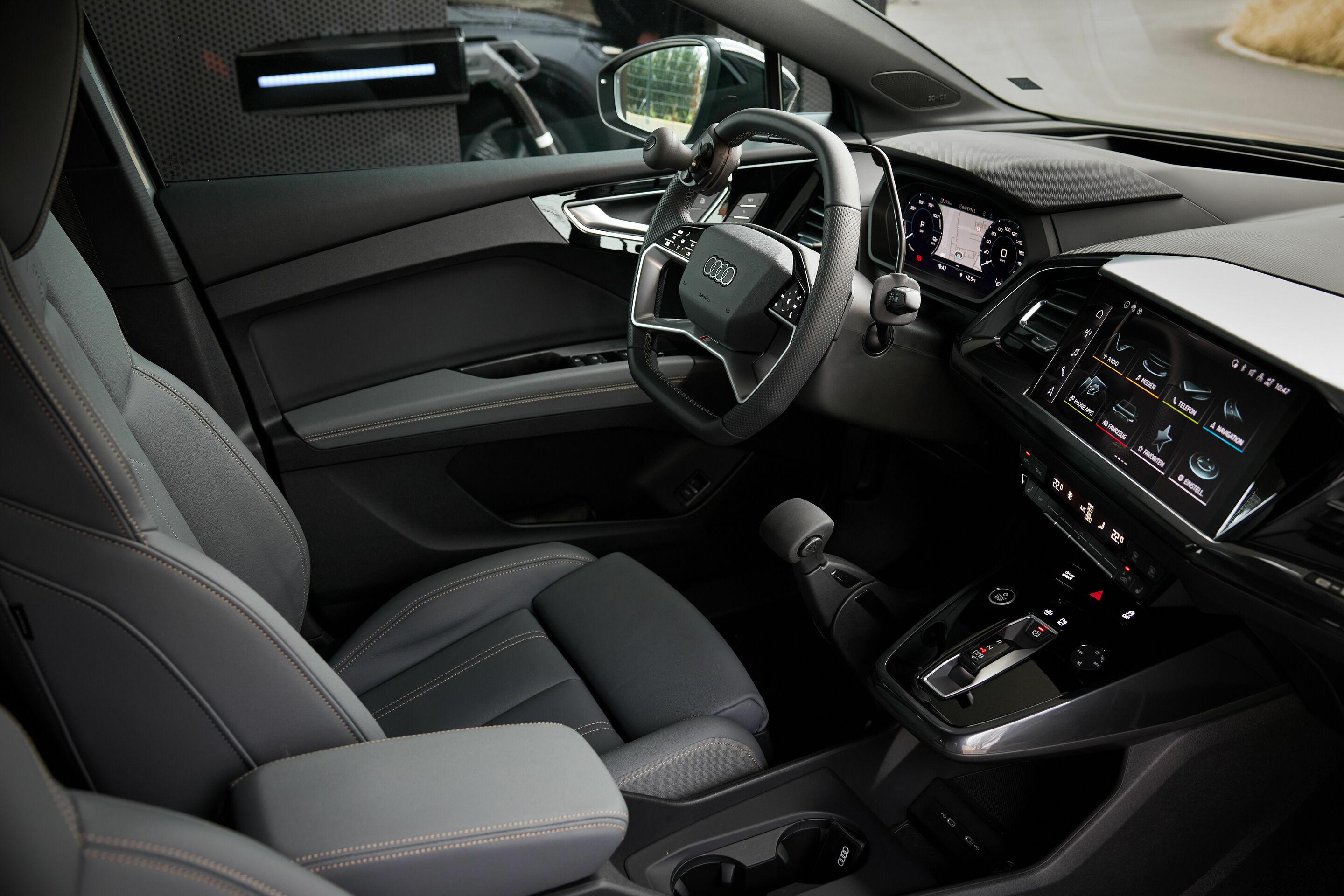 Audi charging hub Frankfurt - For people with mobility requirements, the Q4 e-tron series is available with driving aids fitted at the factory. In 2007, Audi became the first automaker to put driving aids in their configurator. In this picture: A compact...