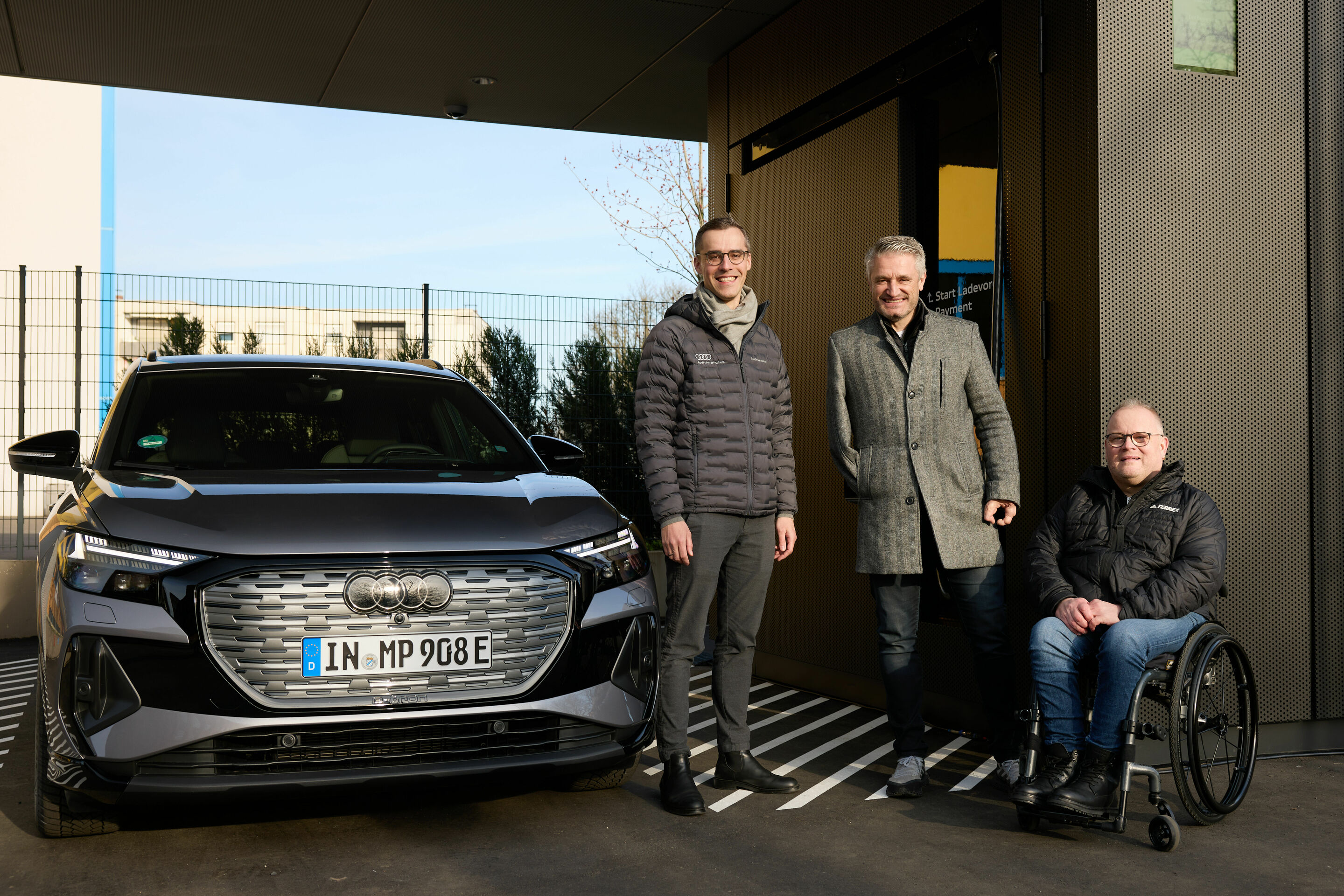 Audi charging hub Frankfurt - Rollout Manager Nikolai Senst, brand ambassador Gerd Schönfelder, and Audi customer Uwe Herrmann.