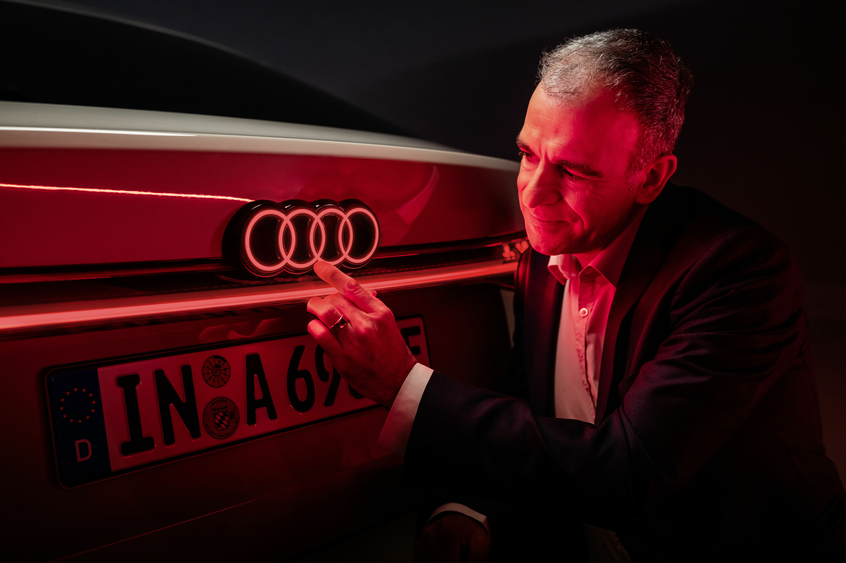 Illuminating insights! - Stefan Staudacher, head of rear lighting development, examines the rear of the new Audi A6 Sportback e-tron, the first Audi model on the European market to feature illuminated rings.