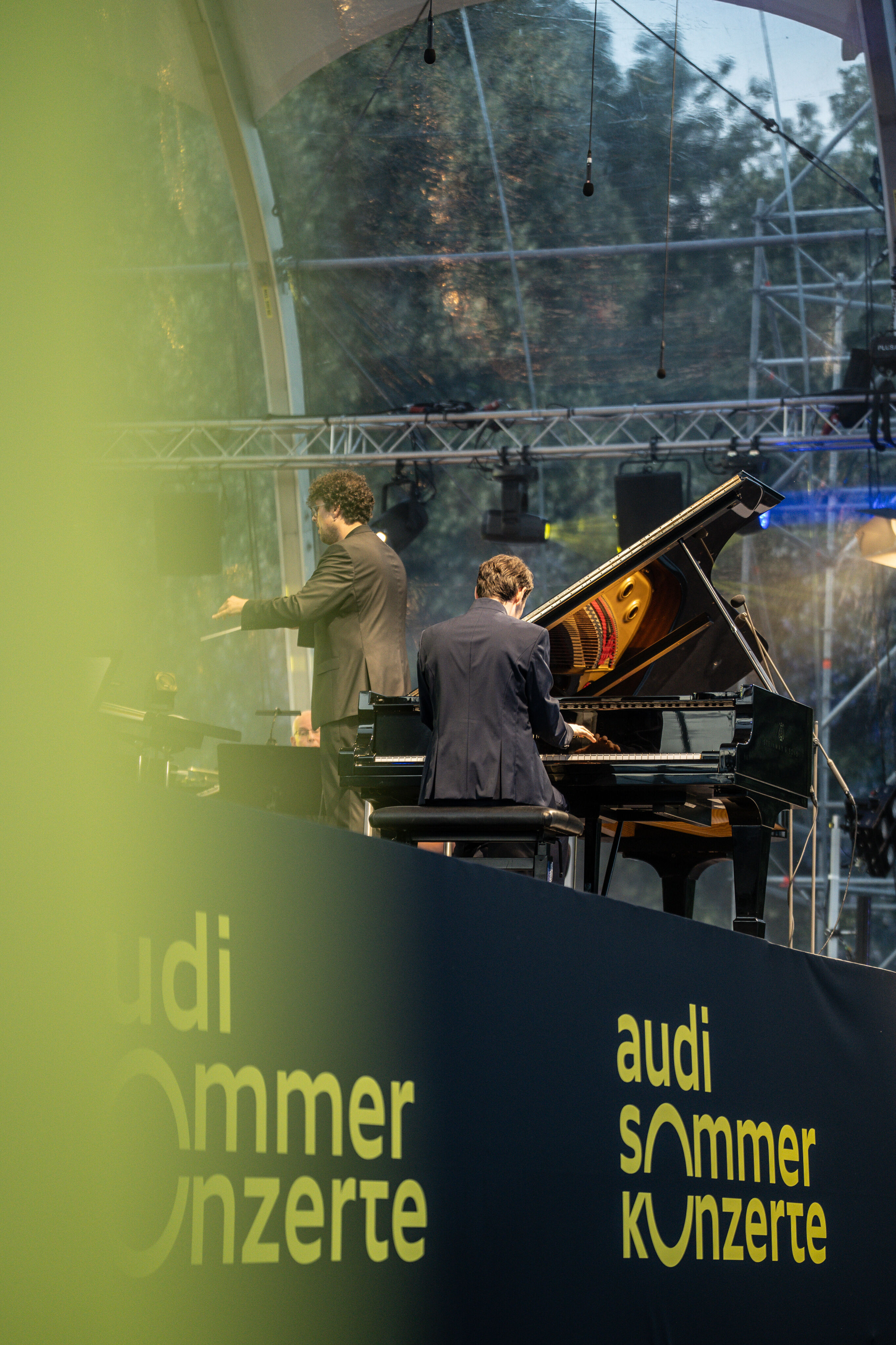 Classic Open Air – musical highlights with the Audi Philharmonic Wind Orchestra - Florian Glemser can be seen playing the piano at the Classic Open Air event in Klenzepark as part of the Audi Summer Concerts; to his left is Pietro Sarno, conductor of...