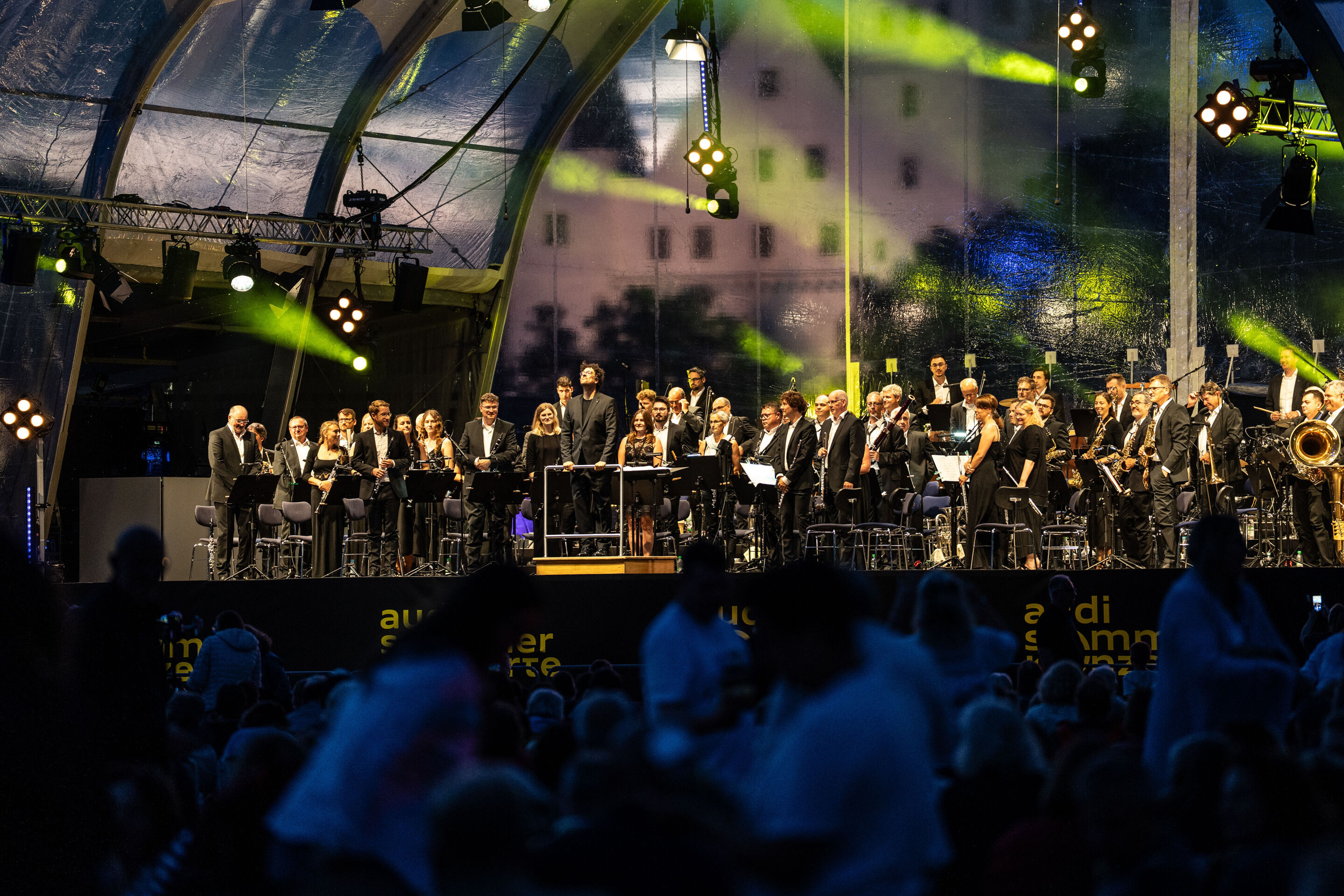 Classic Open Air – musical highlights with the Audi Philharmonic Wind Orchestra - The Audi Philharmonic Wind Orchestra and conductor Pietro Sarno stand on stage at the Classic Open Air event in Klenzepark as part of the Audi Summer Concerts.