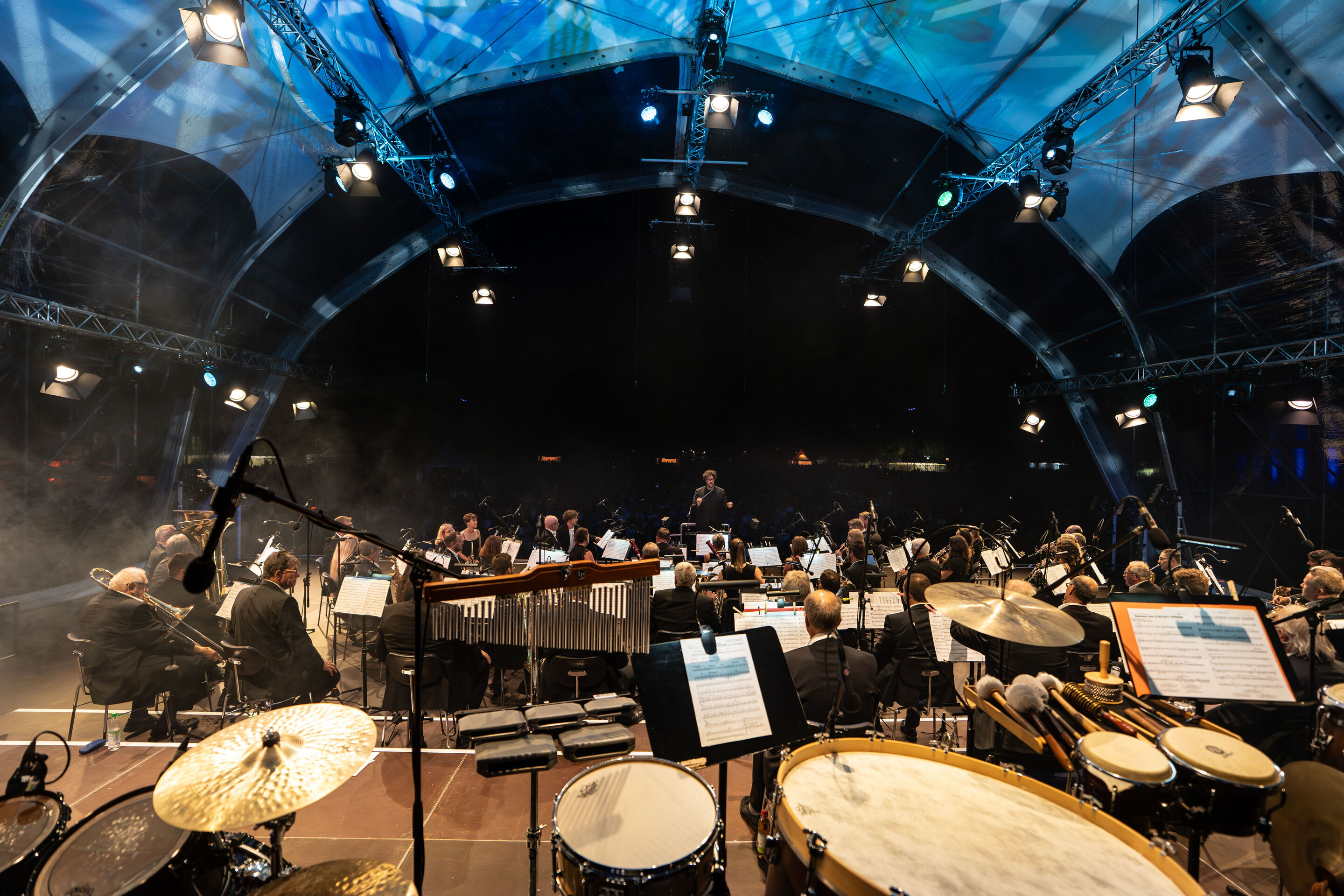 Classic Open Air – musical highlights with the Audi Philharmonic Wind Orchestra - View from the back of the stage looking out to the audience: Pietro Sarno conducts the Audi Philharmonic Wind Orchestra at the Audi Summer Concerts Classic Open Air event...