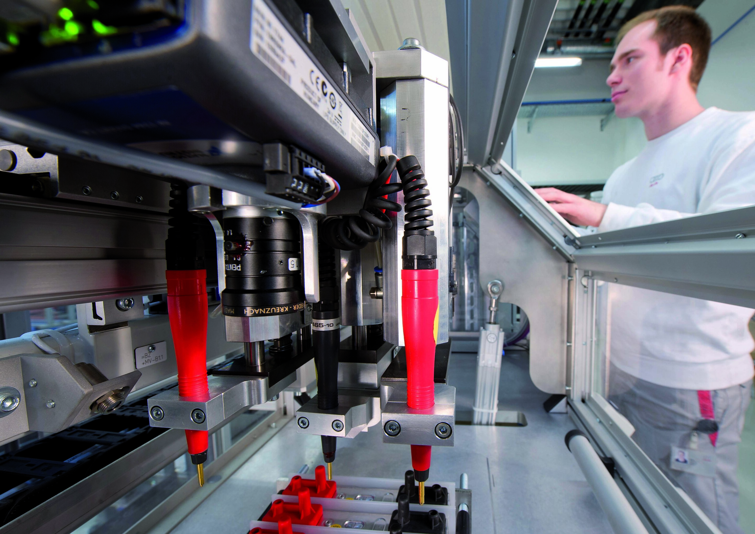 High-Voltage Battery Project House - An employee monitors the measuring process for battery cells.
