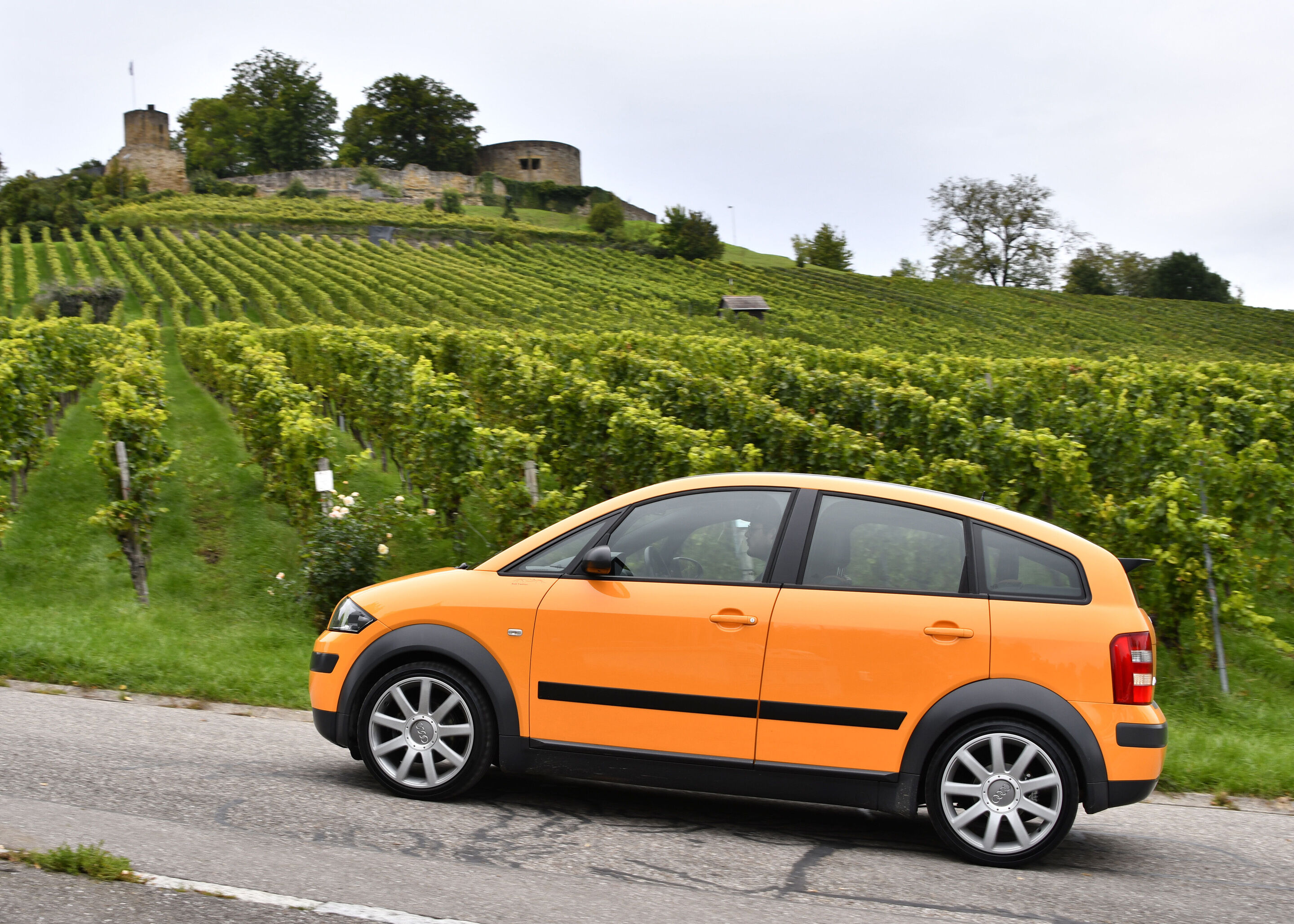 Leading light: 25 years Audi A2 - The Audi A2 was launched in 2000 – 25 years ago. The picture shows a side view the special “colour.storm” edition in Papaya orange, rolling shot.