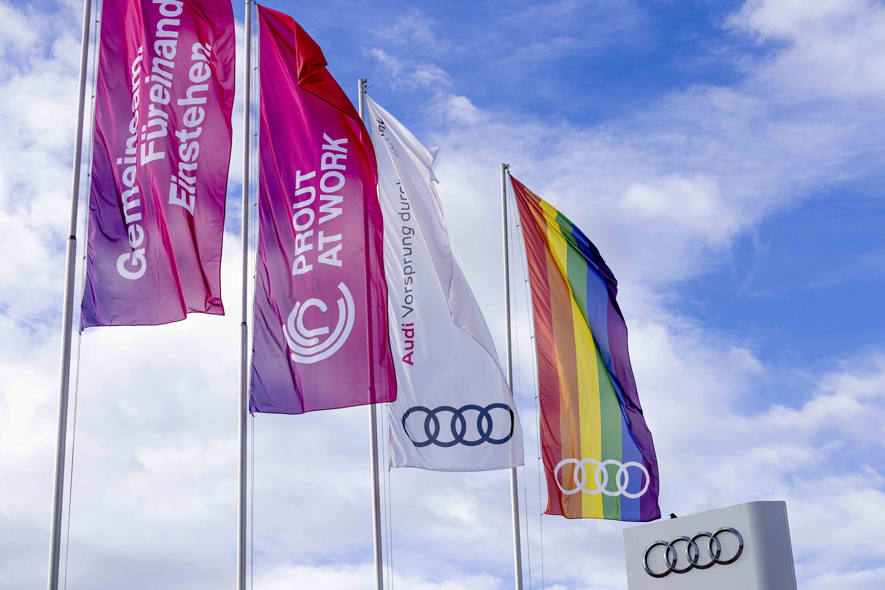 Diversity in Focus: “Prout at Work” at Audi - Audi and “Prout at Work” flags in front of the Audi Forum Ingolstadt.