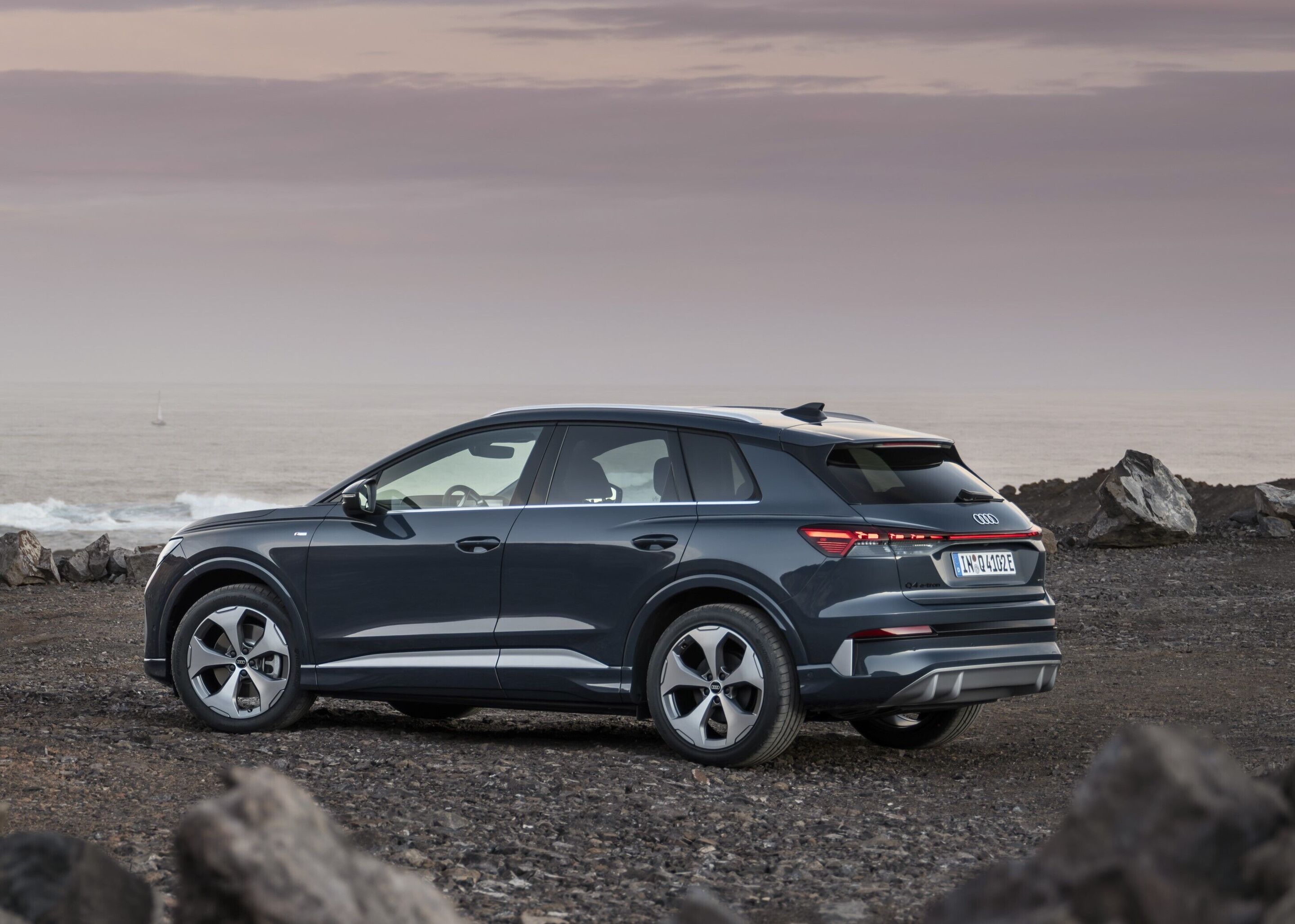 Audi Q4 SUV e-tron - Plasma blue, outdoor static photo, exterior, three-quarter rear view