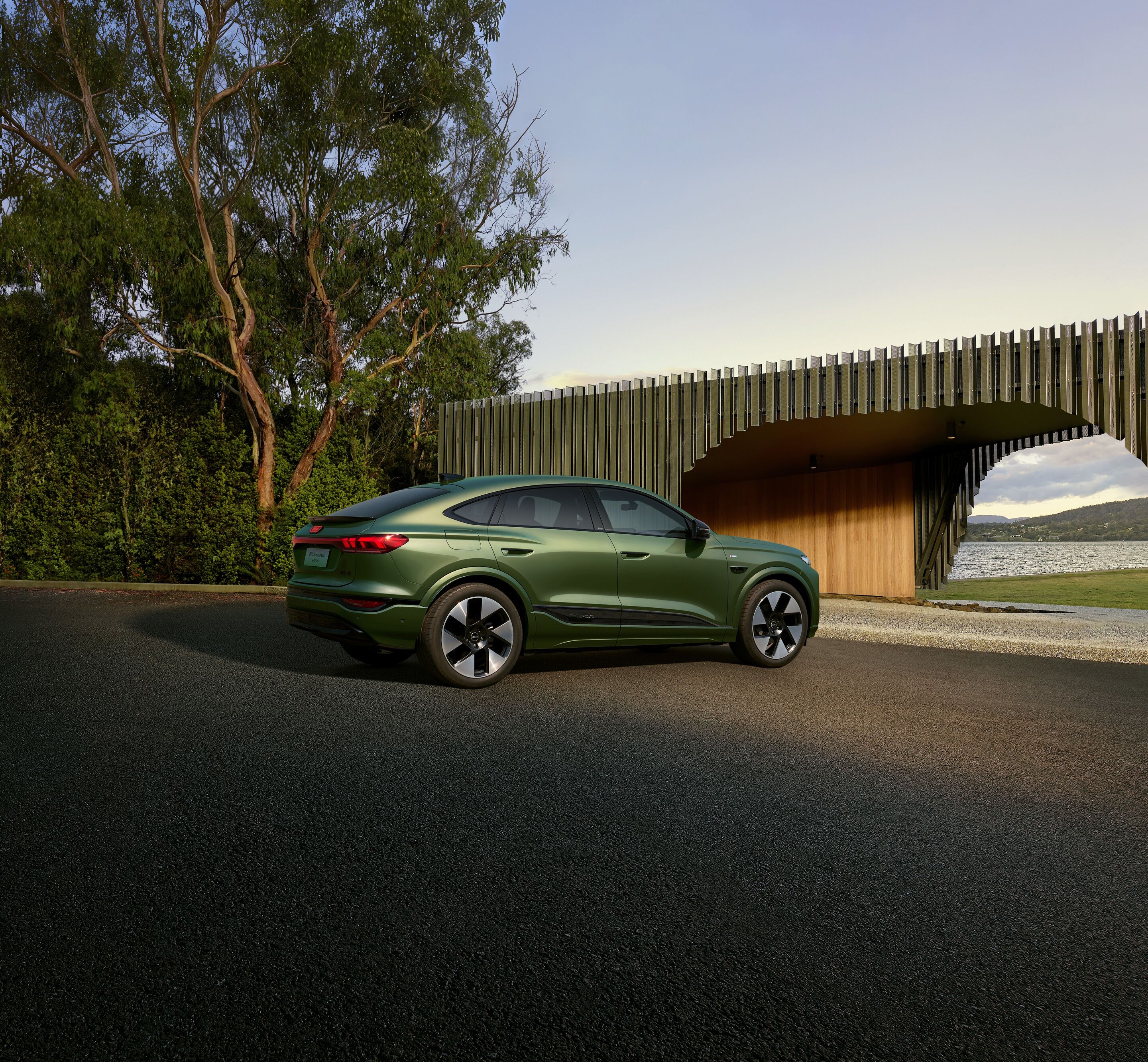Audi at Auto China 2026 - Audi Q6L Sportback e-tron, outdoor static shot, exterior, three-quarter rear view in front of a scenic landscape