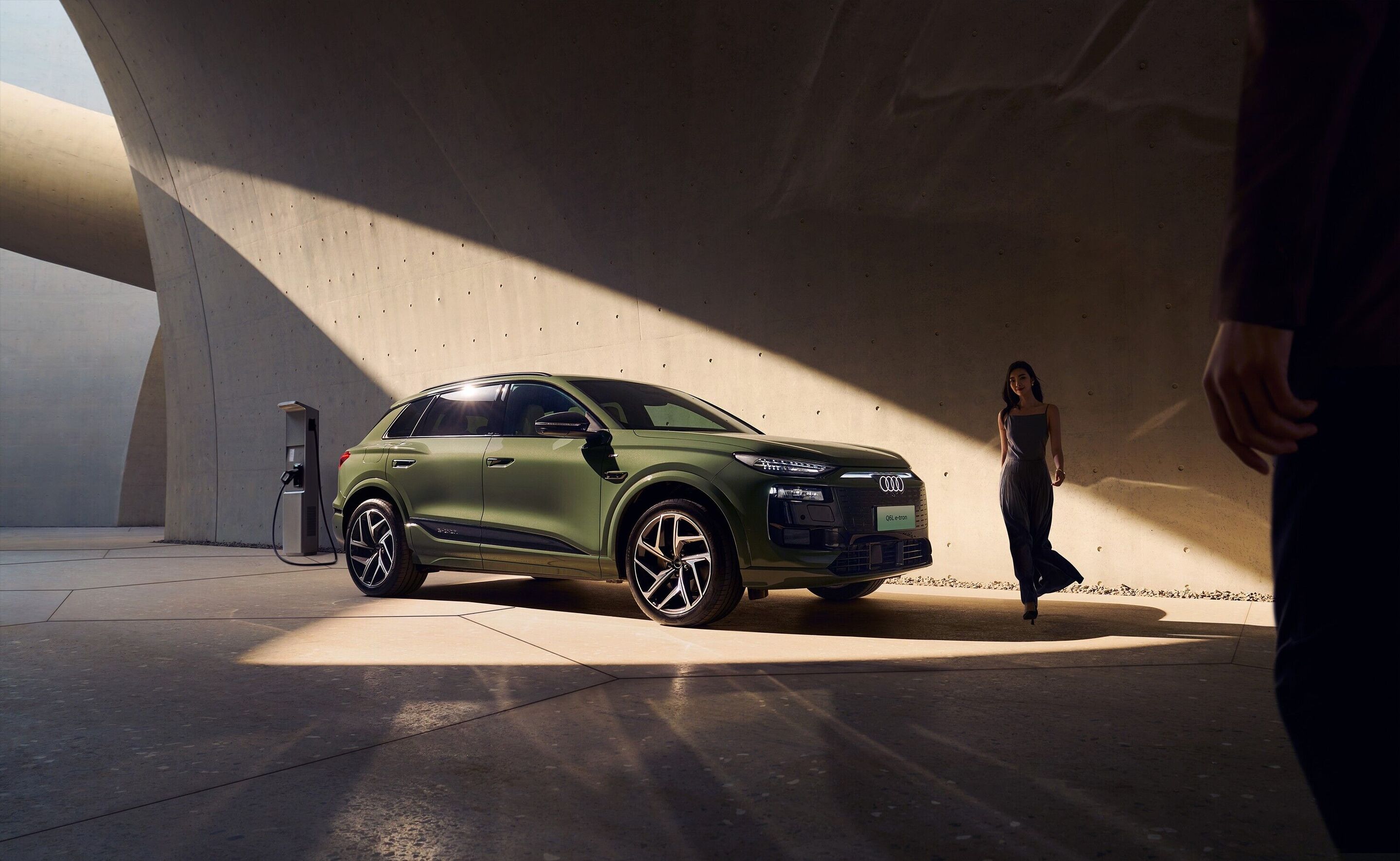 Audi at Auto China 2026 - Audi Q6L e-tron, outdoor static shot, exterior, three-quarter front view with charging infrastructure
