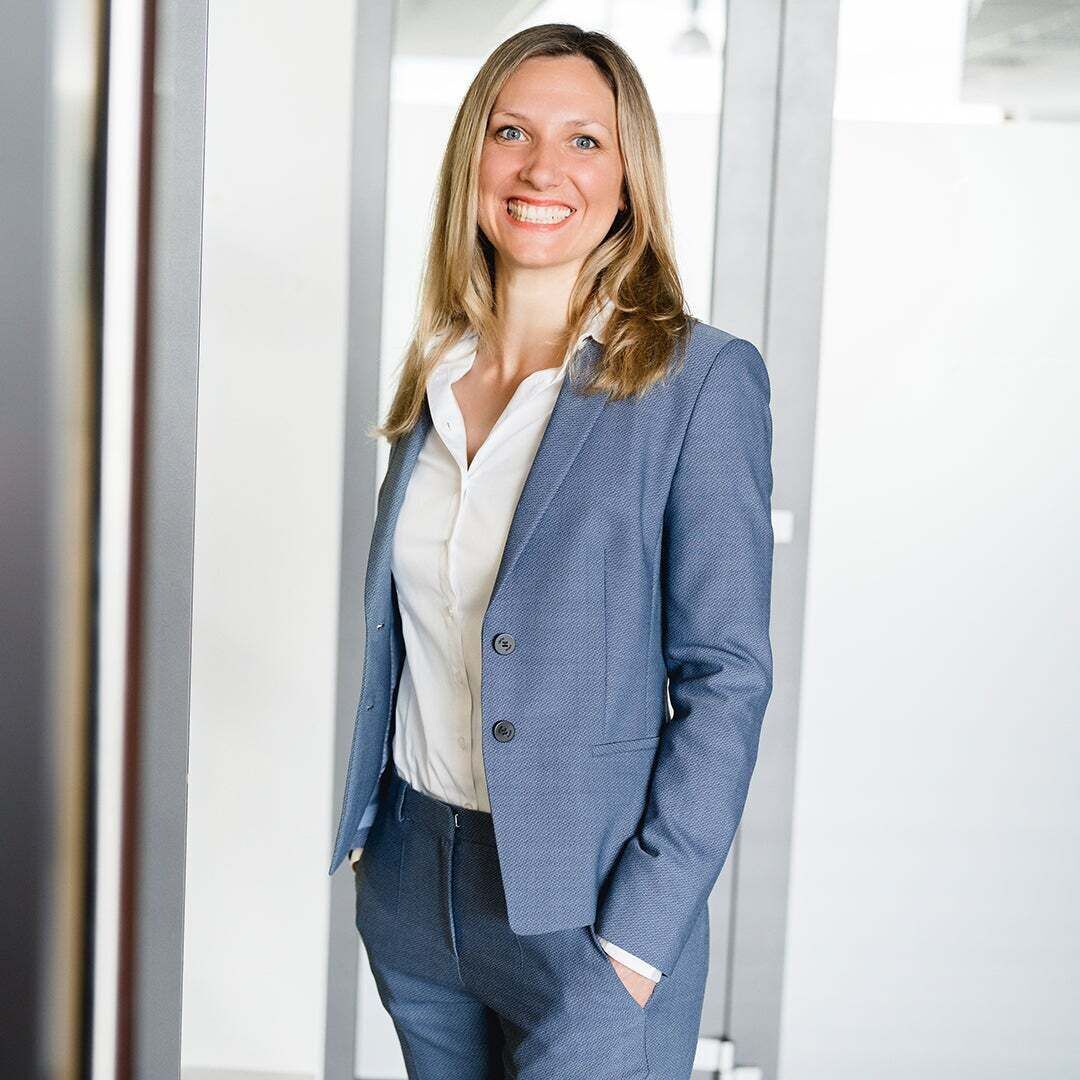 A woman laughs into the camera