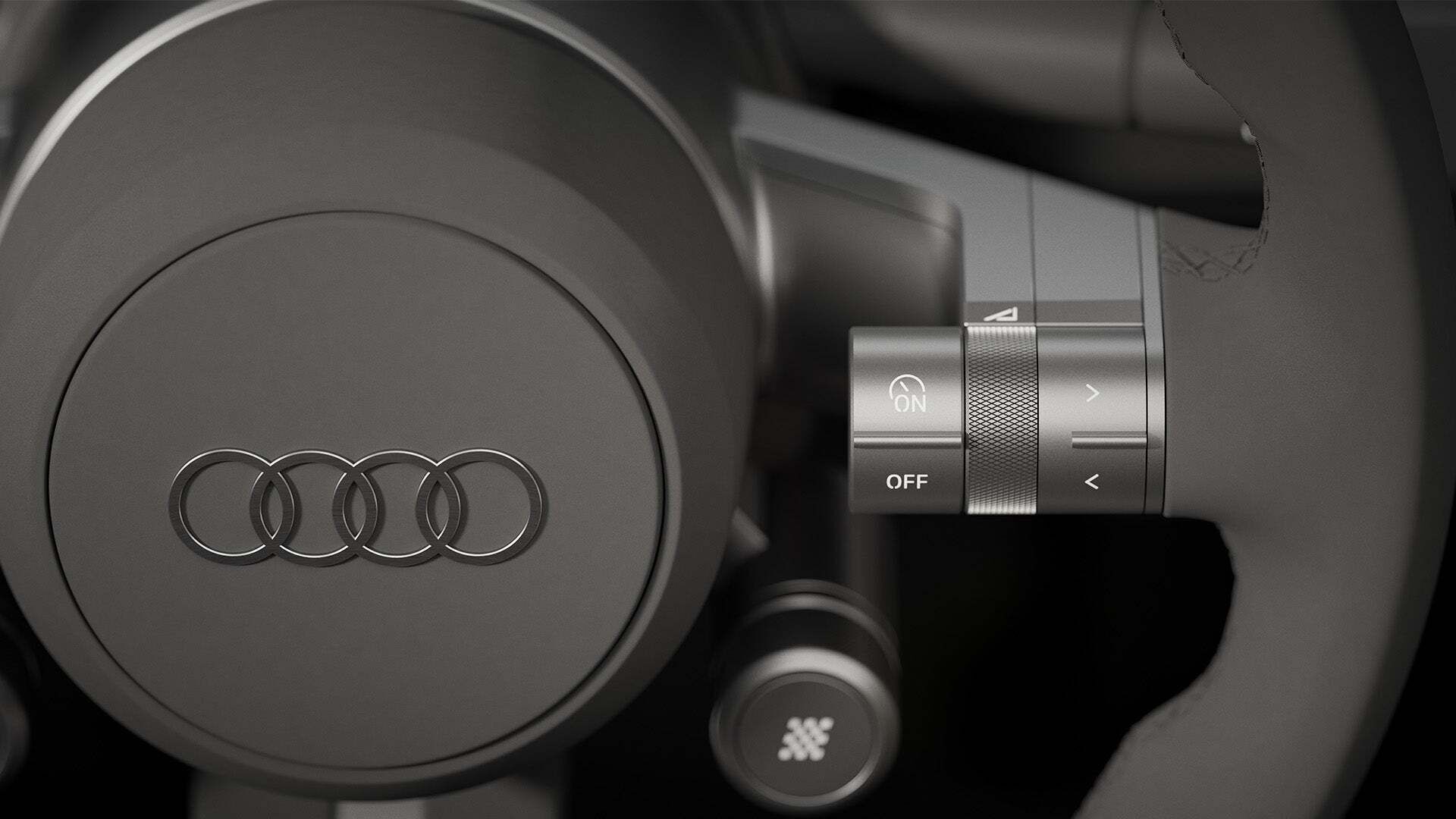 Topansicht eines Audi TT-Models mit offenem Verdeck vor grauem Hintergrund.