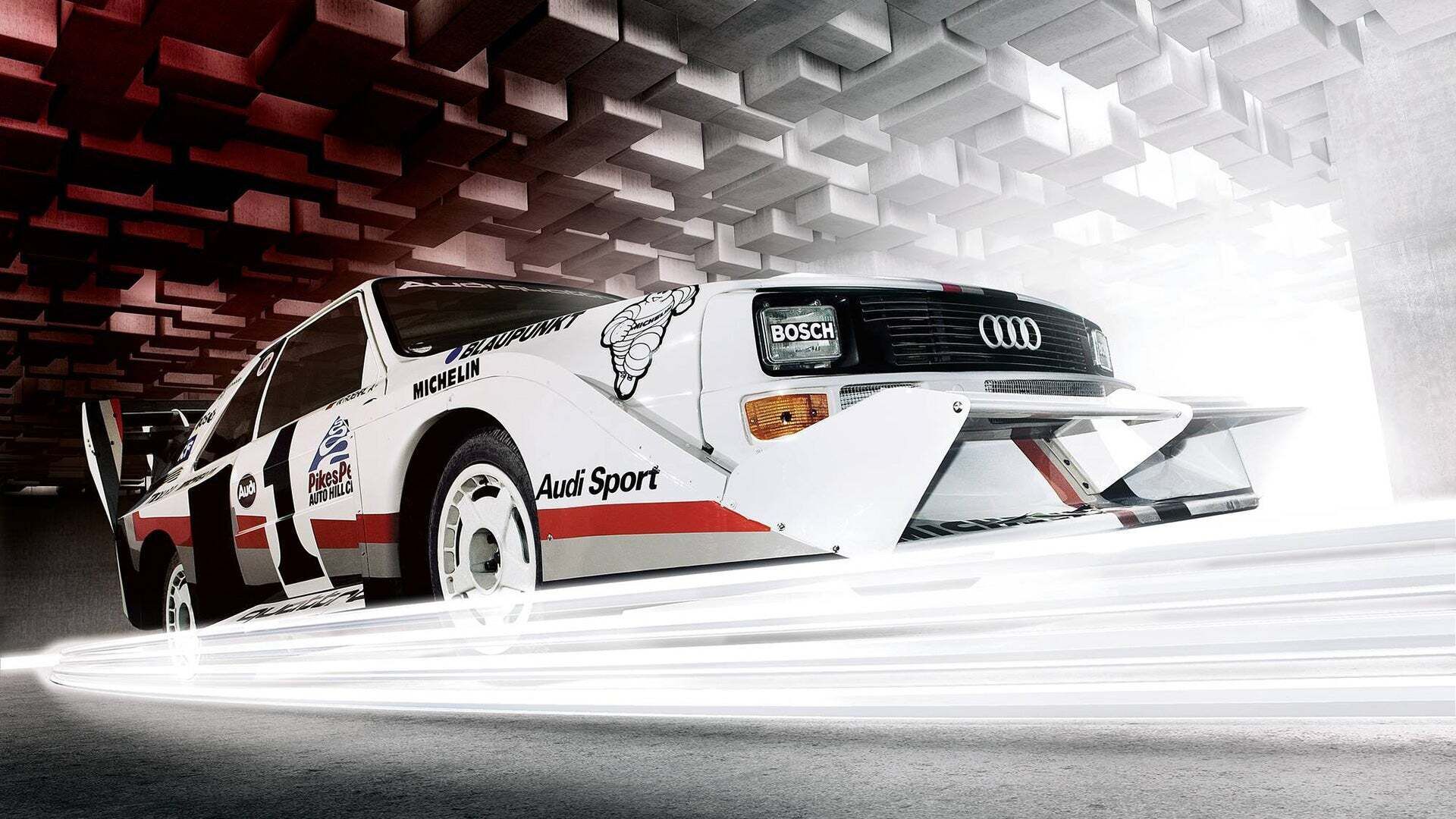 Historic Audi rally car in a soundproof test room.