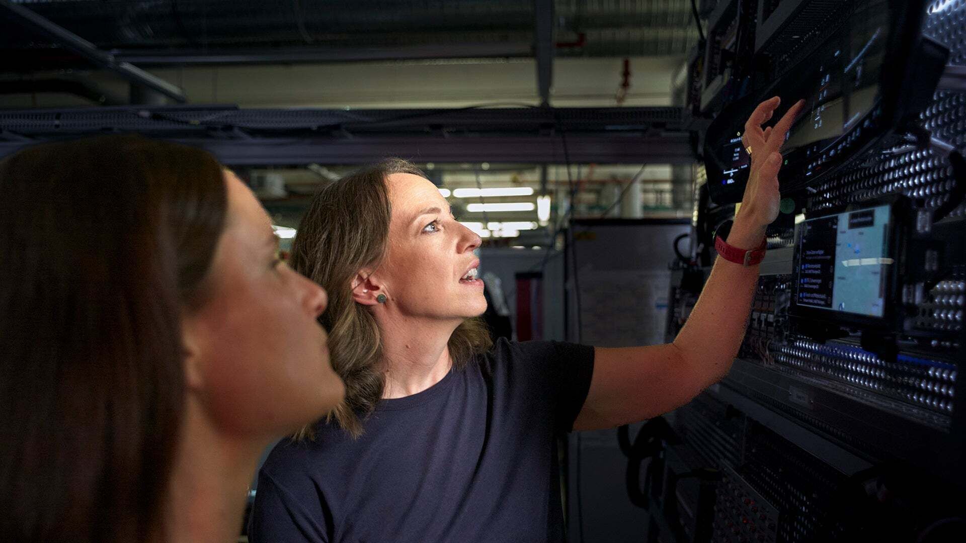Melanie Limmer shows a colleague something on a device