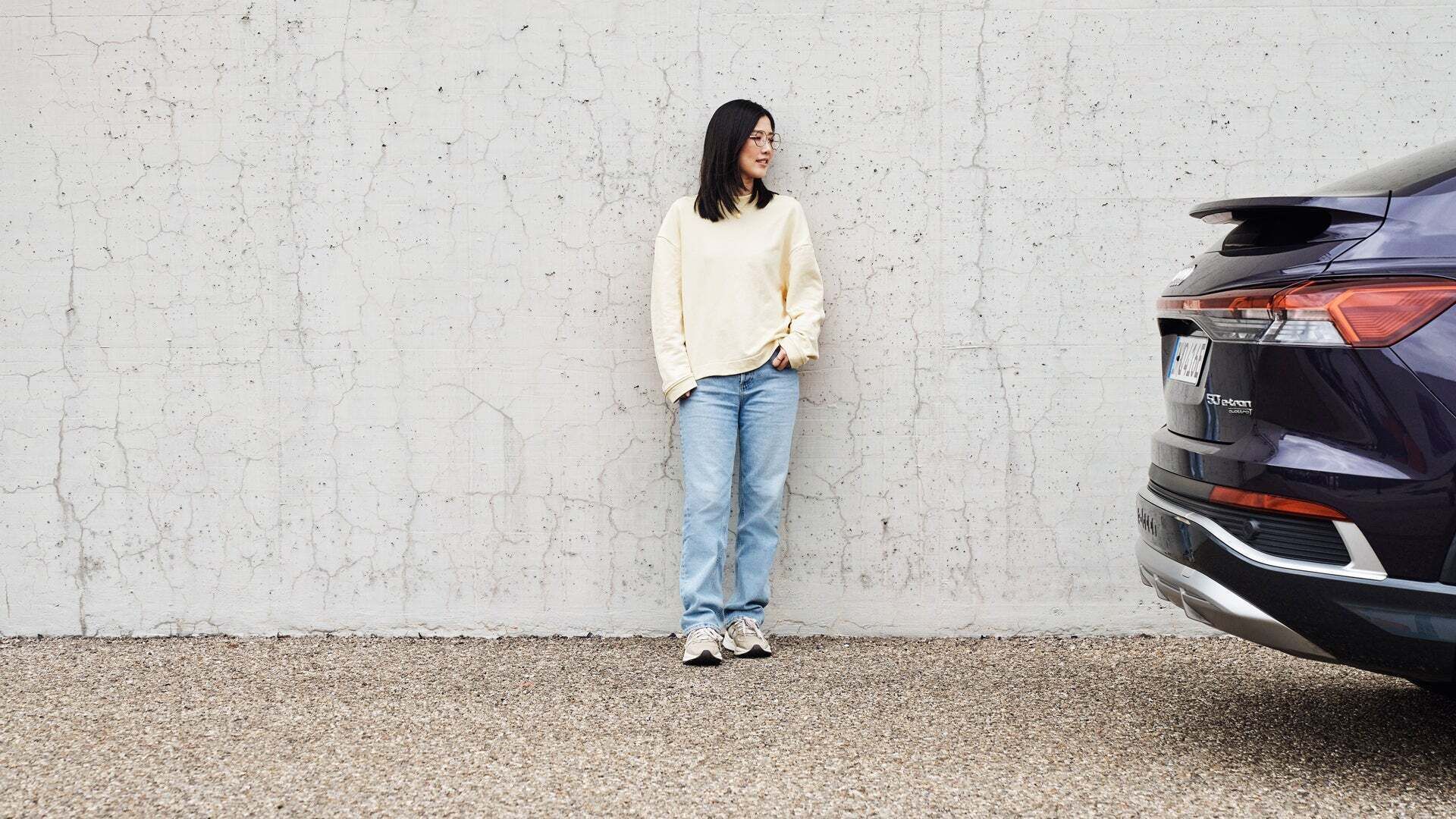 Tiantan standing at a wall, looking left