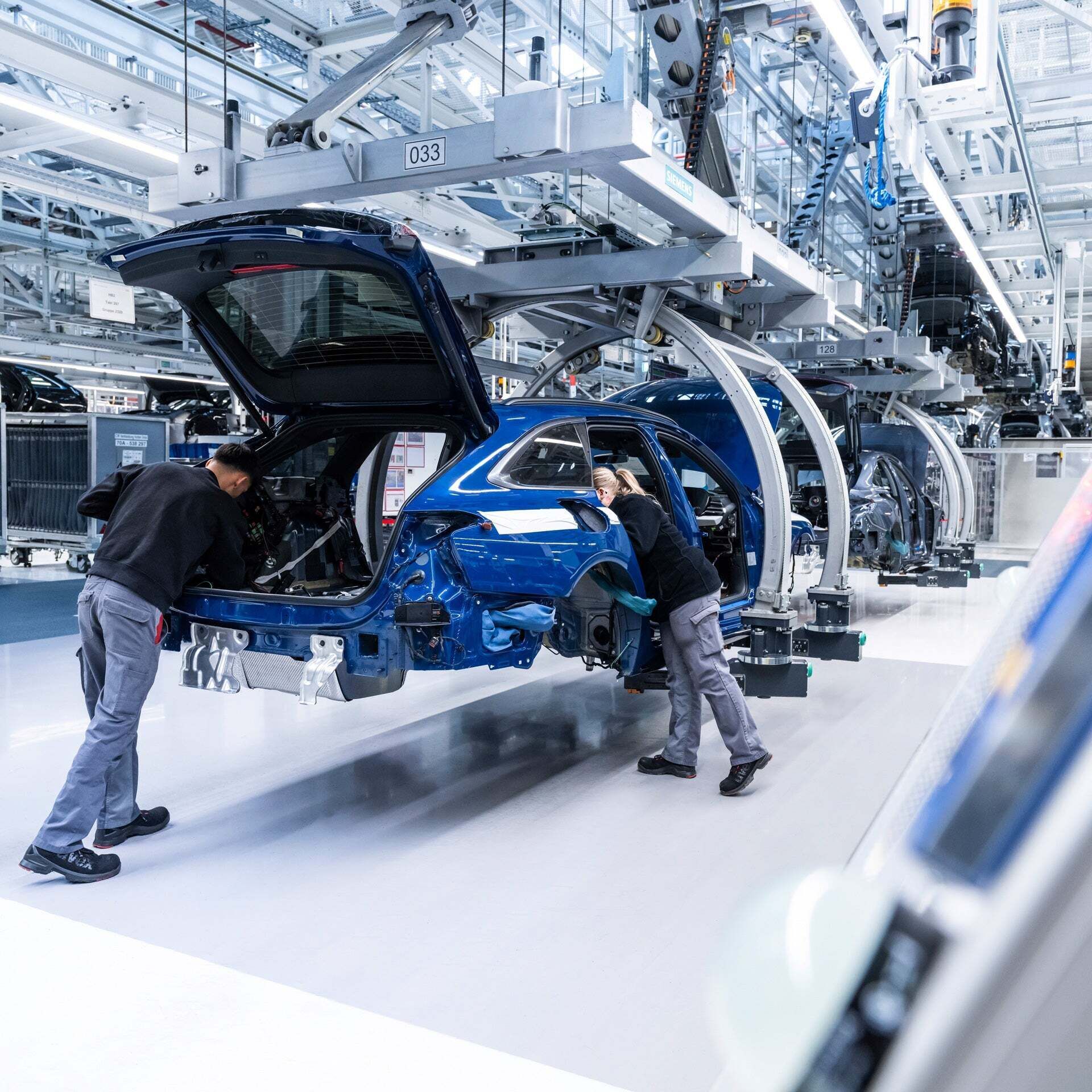 Two employees installing parts in production.