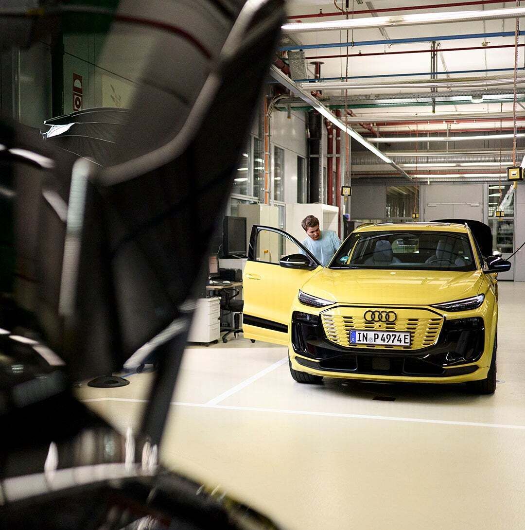 Jan Totz gets into a yellow Audi in a workshop