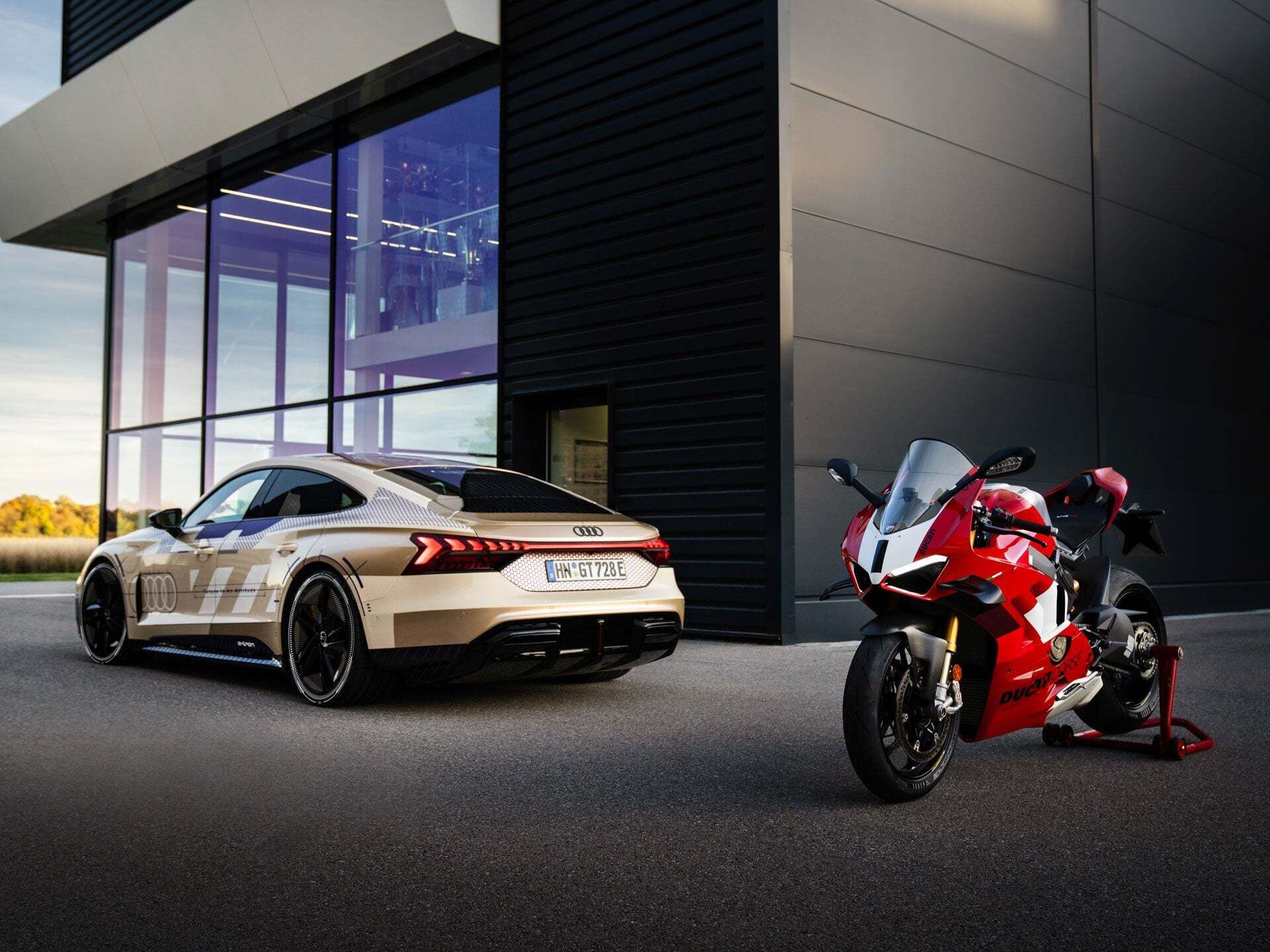 Rear view of the Audi e-tron GT next to the Ducati Panigale V4 R