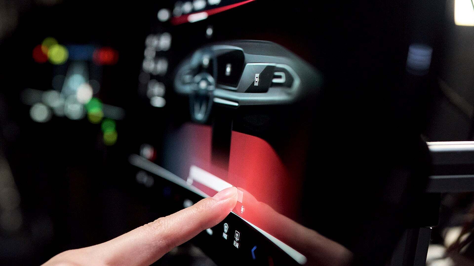 A hand taps a display with one finger