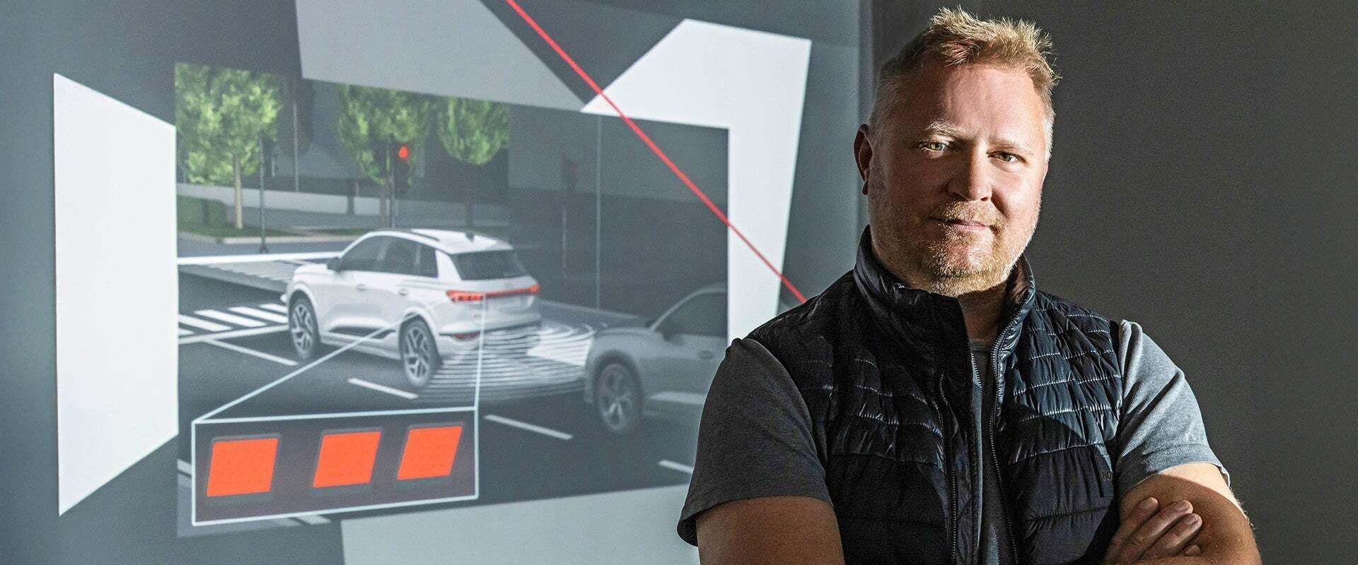 Portrait of Thomas Bleier next to a presentation on vehicle safety