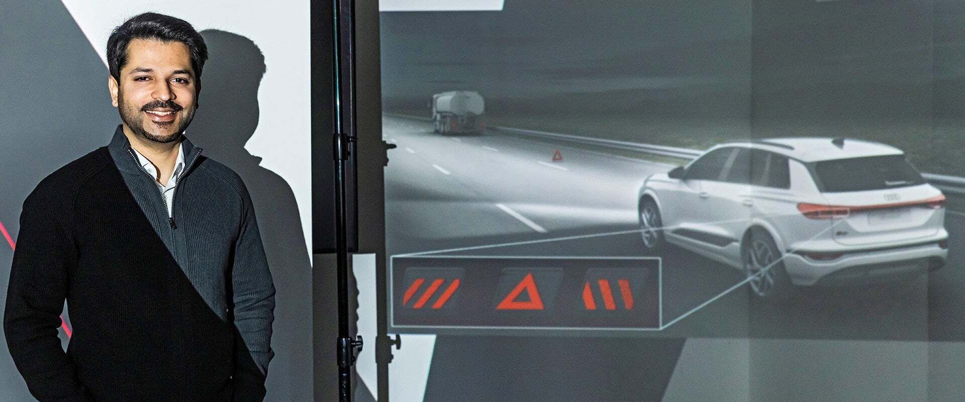 Portrait of Mamoon Nomaan next to a presentation on vehicle safety