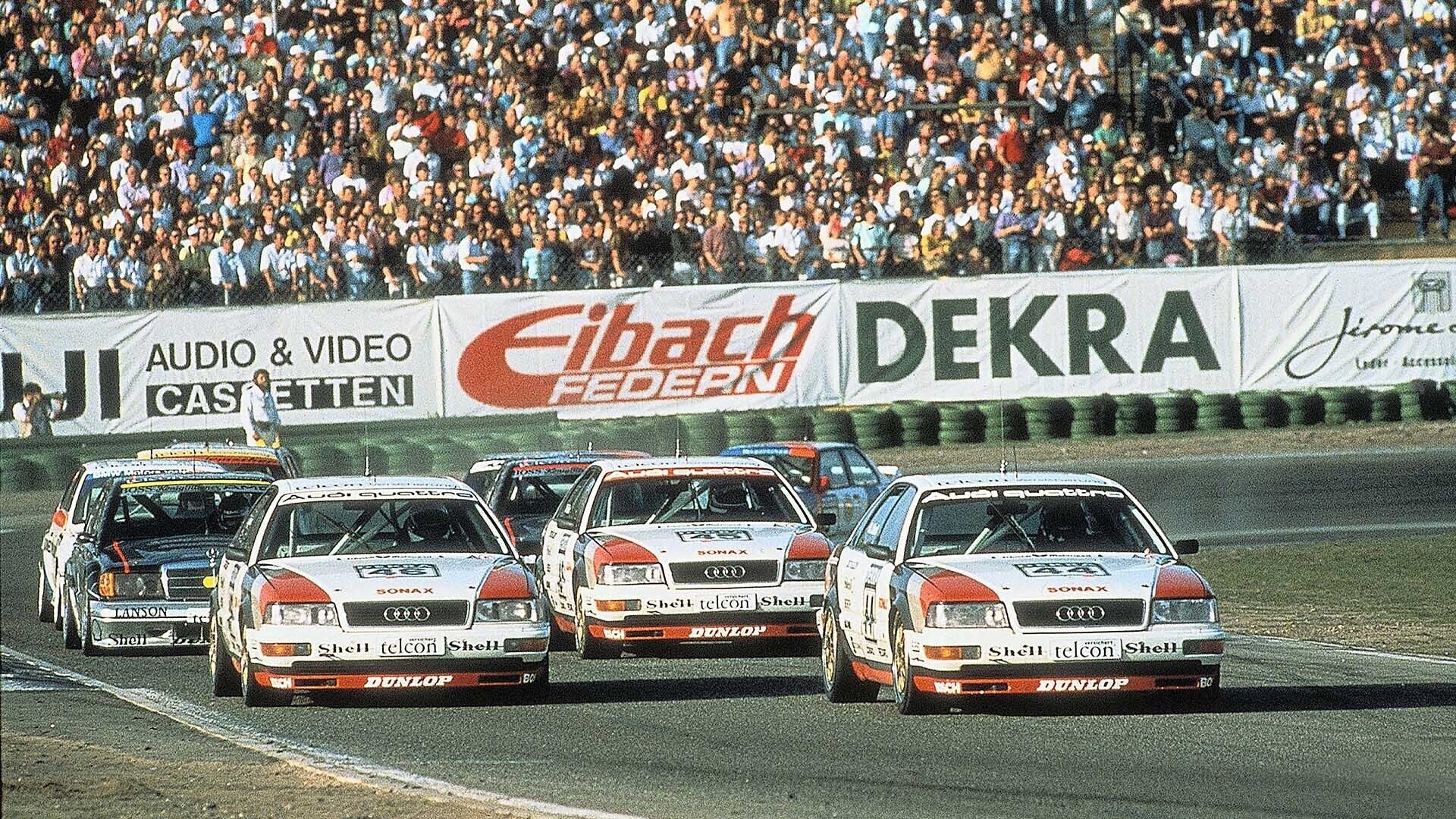 A picture showing three Audi V8 quattro race cars on track at Hockenheim in 1990.