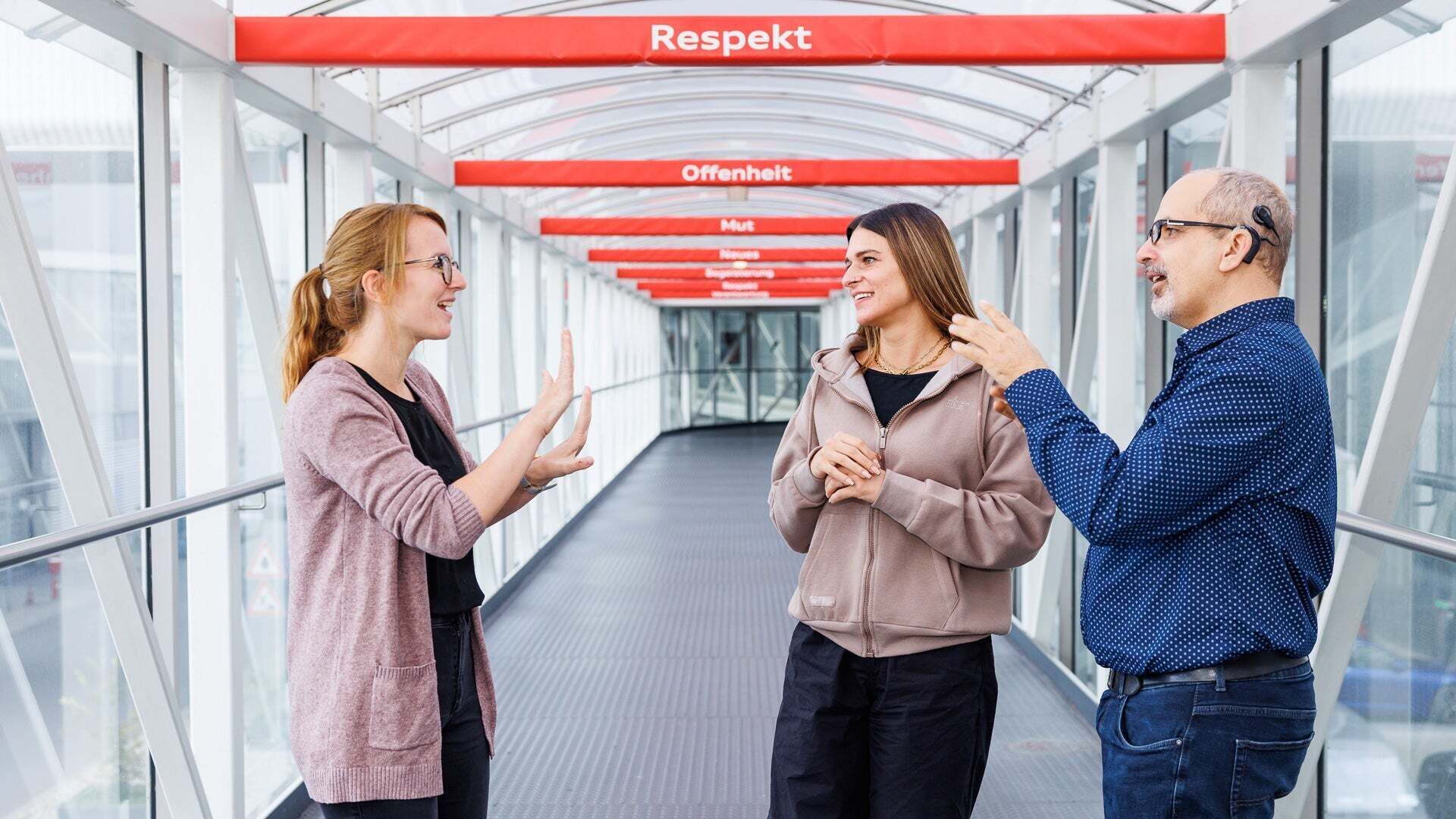 Audian Vanessa (center) with sign language interpreter Vanessa Stöhrl and her colleague Mathias.