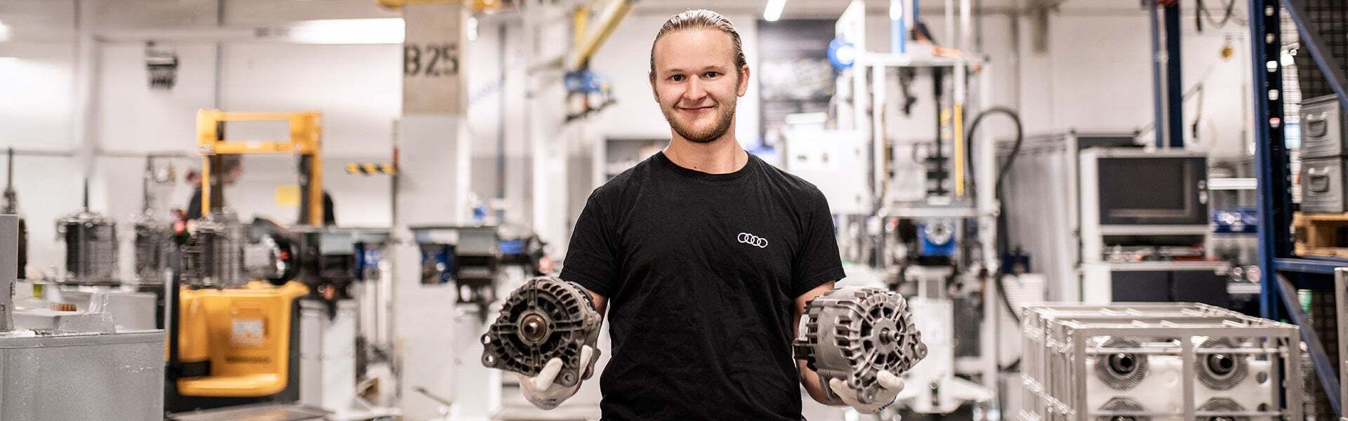 An employee presents two components in production