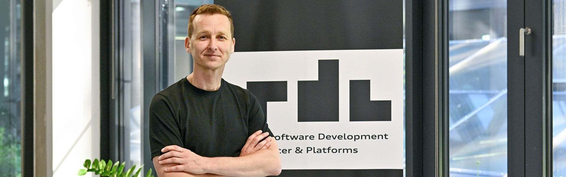 Alex, Office Lead SDC, looks into the camera with his arms crossed