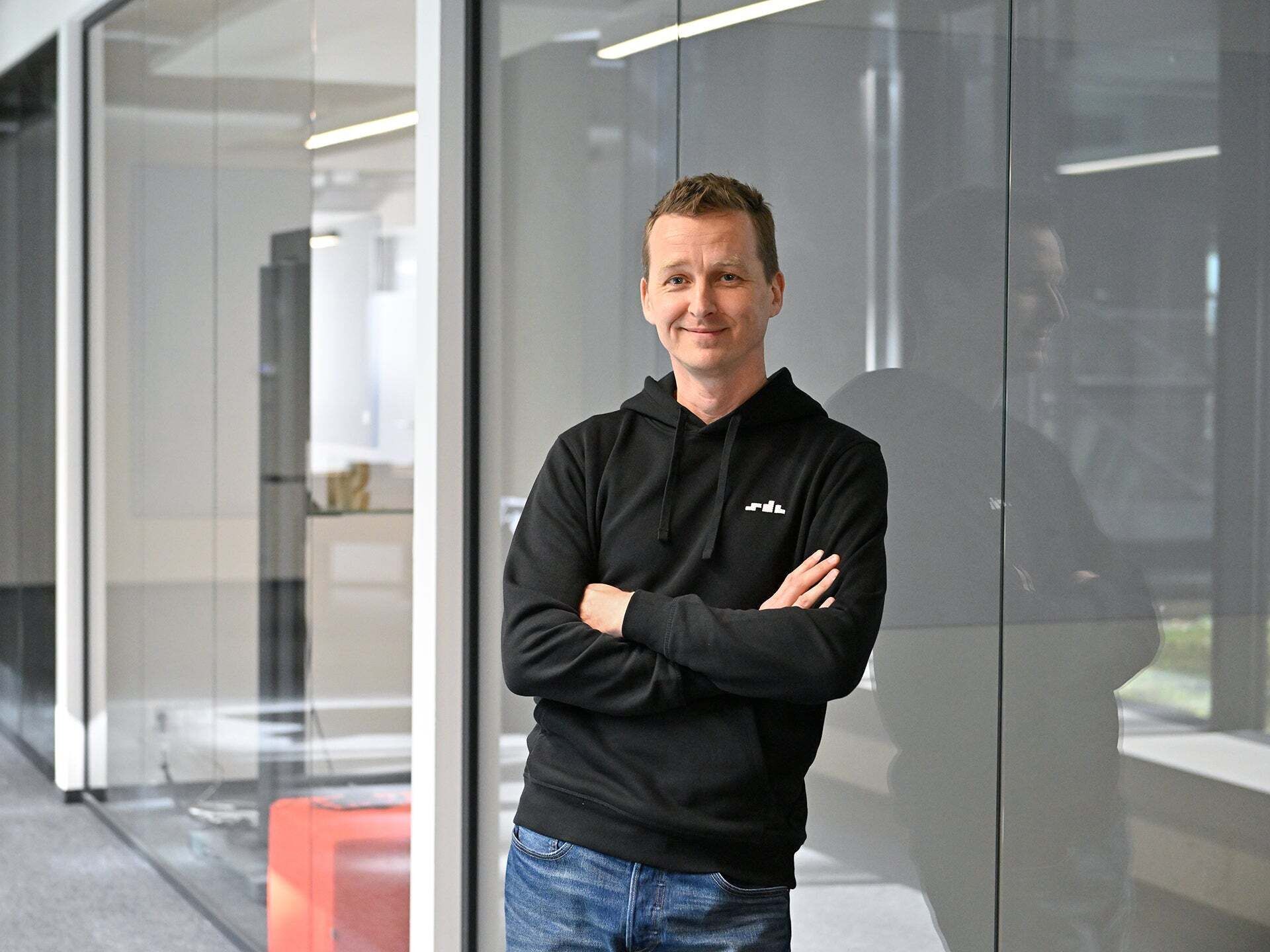 Alex, Office Lead SDC, looks into the camera with his arms crossed