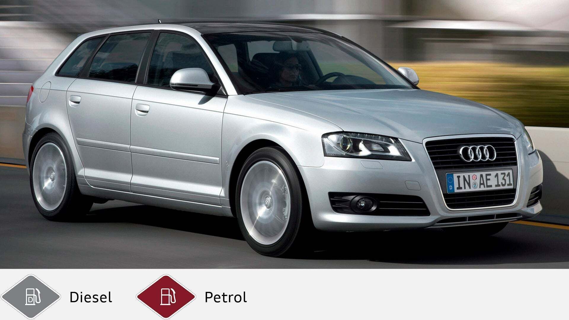 Silver Audi A3 Sportback driving on the road with driver at the wheel, diagonally from the front. Gray diesel symbol and red petrol symbol at the bottom.