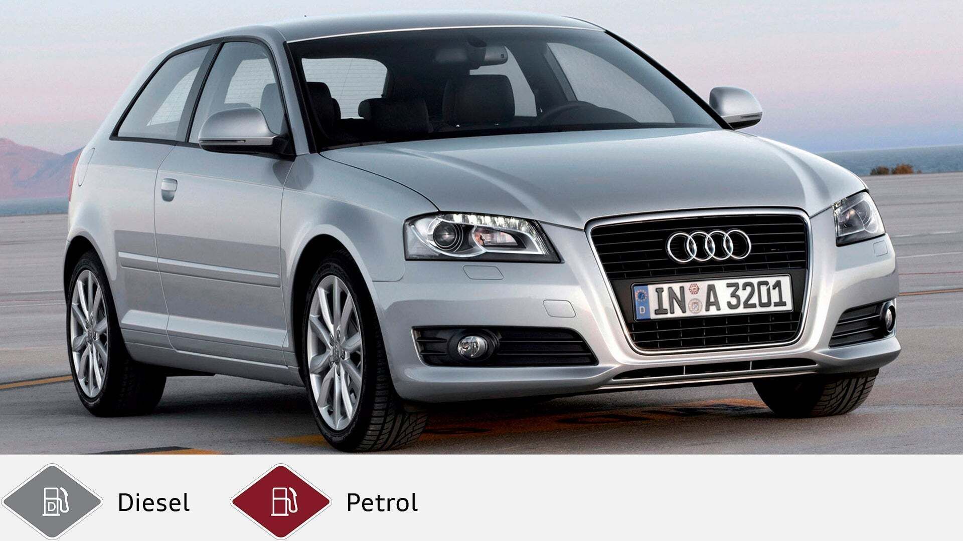 Silver Audi A3 three-door car standing on a light-colored surface, photographed at a slight angle from the front. Gray diesel symbol and red petrol symbol at the bottom.