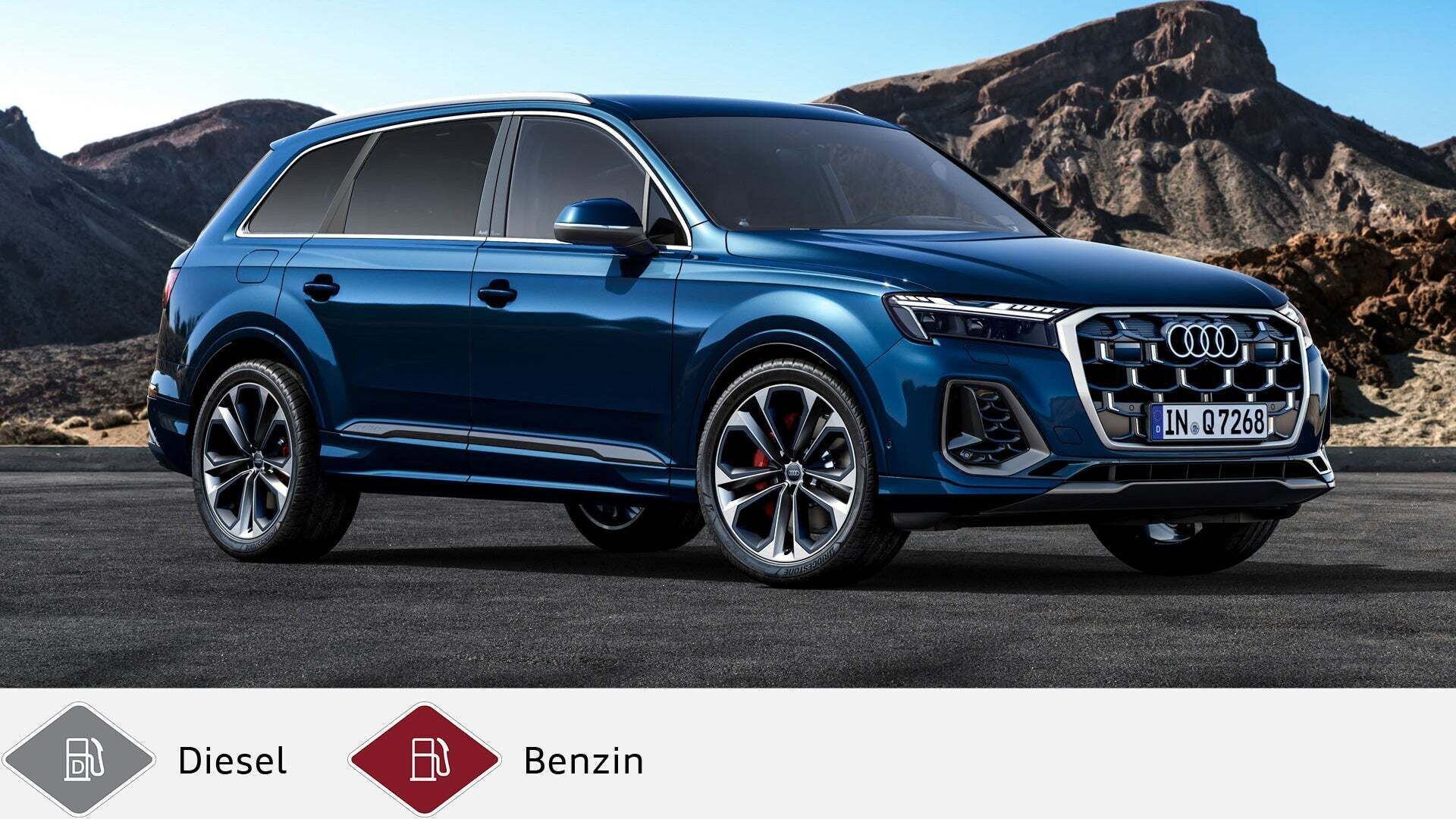 Blauer Audi Q7 SUV steht vor felsiger Berglandschaft, leicht seitliche Frontansicht. Unten graues Dieselsymbol und rotes Benzinsymbol.