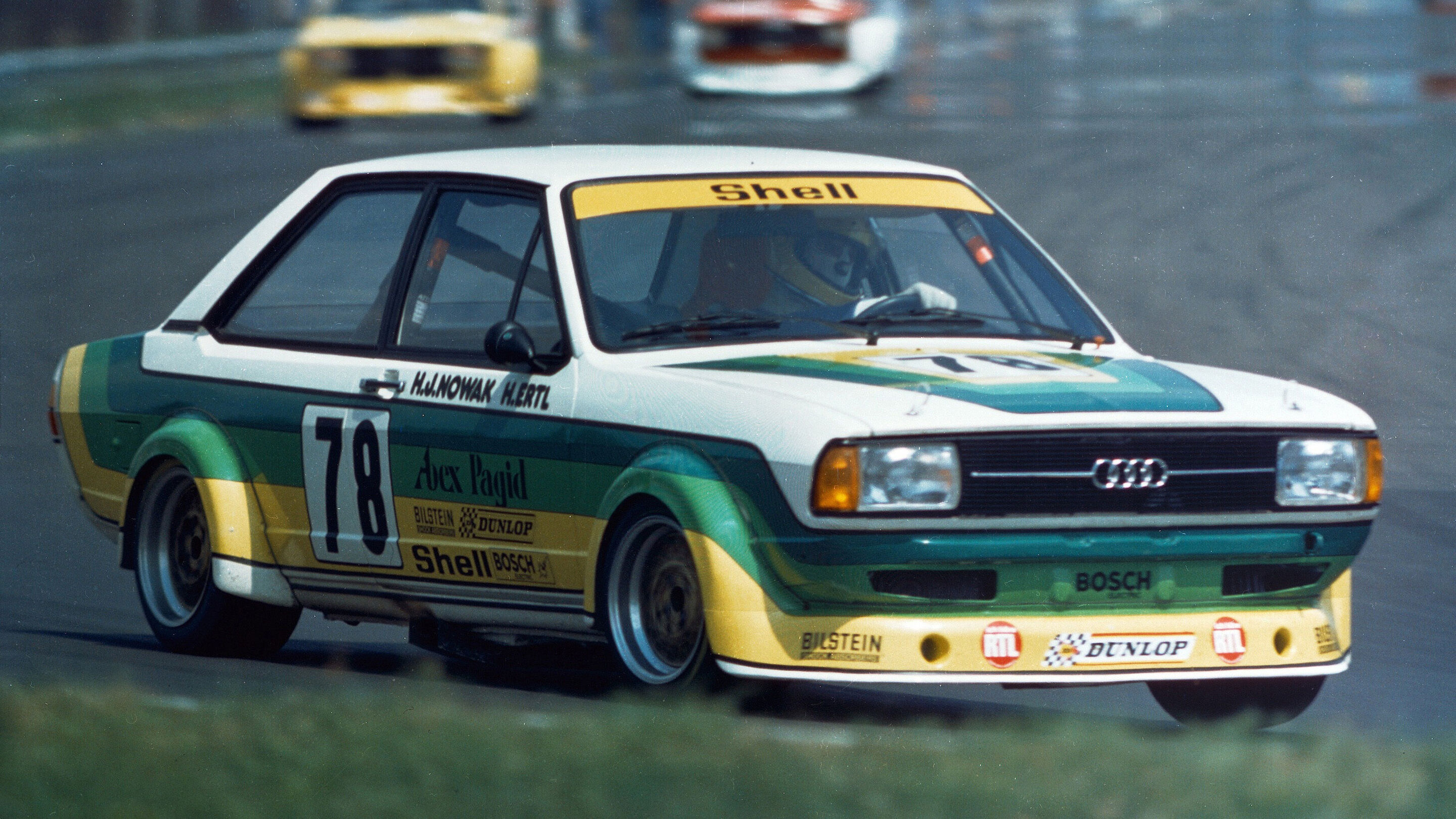 A picture showing an Audi 80 race car on track.