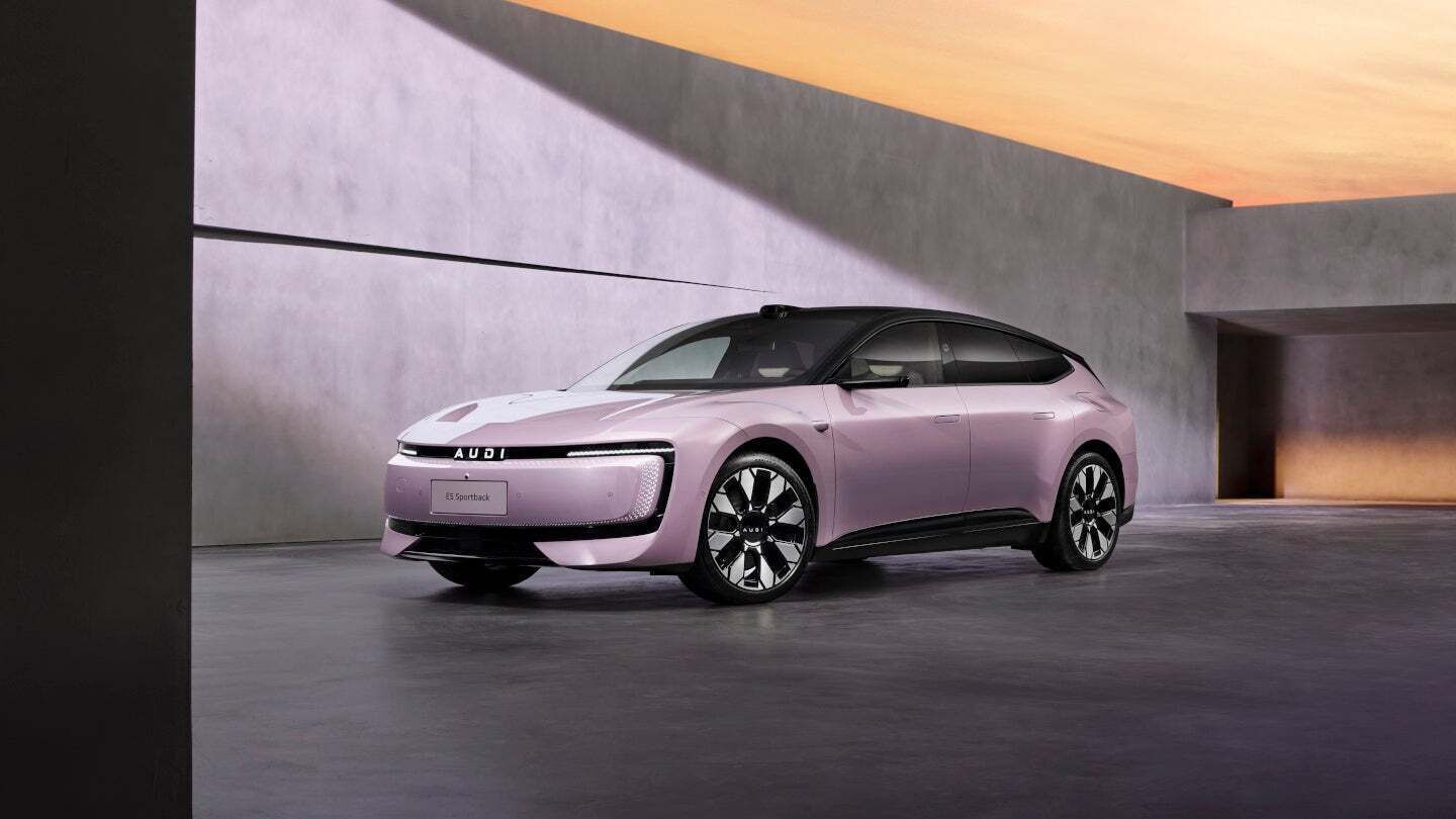 A purple AUDI E5 Sportback is positioned within modern concrete architecture, illuminated by the warm light of the sunset.