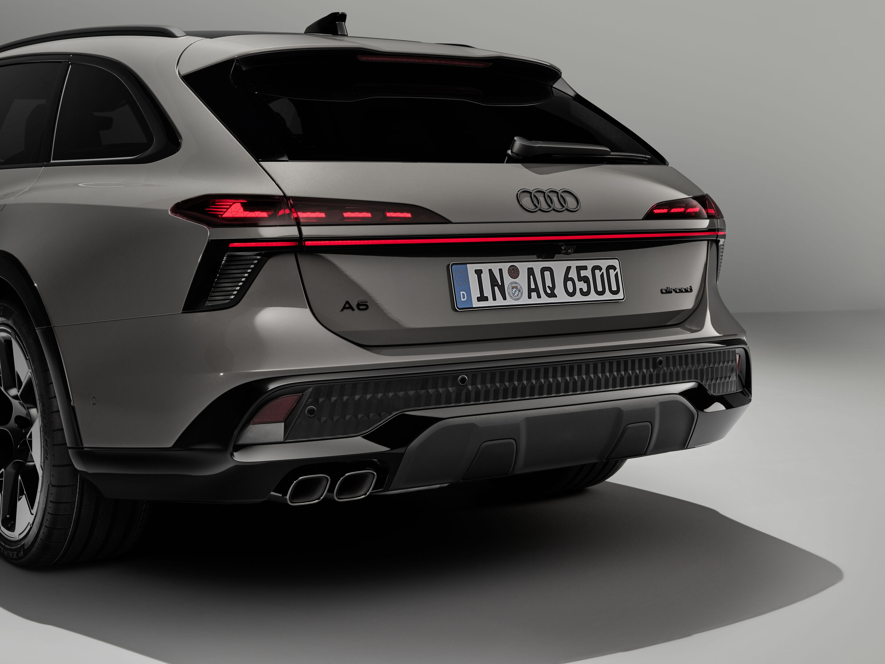 Audi A6 allroad quattro - Audi A6 allroad (plateau grey metallic) rear design detail: Distinctive rear light signatures, the continuous light strip and the large diffusor  define the rear design.