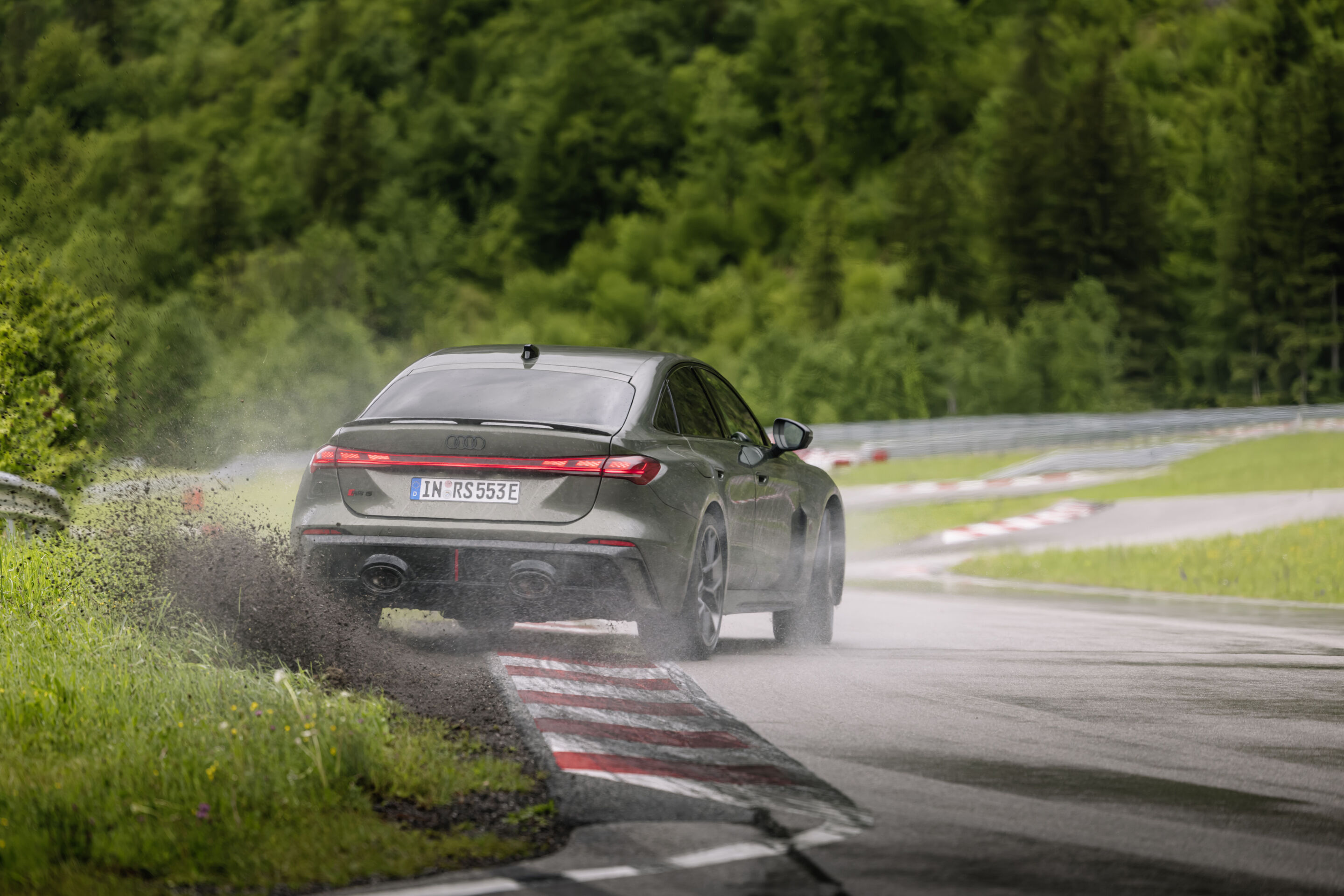 Audi RS 5 Sedan - Audi RS 5 Sedan in Bedford green, outdoor driving shot, exterior, rear view during sporty cornering.