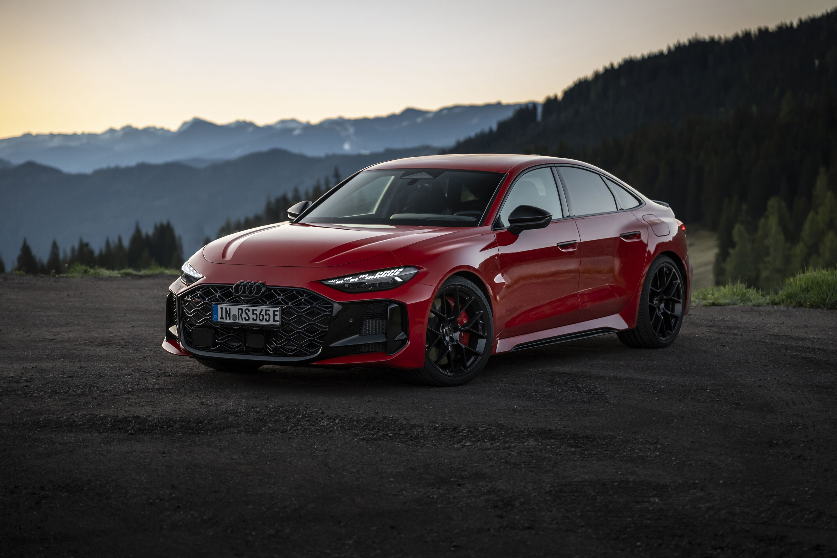 Audi RS 5 Sedan - Audi RS 5 Sedan in Progressive red, outdoor static shot, exterior, in front of an alpine mountain backdrop.
