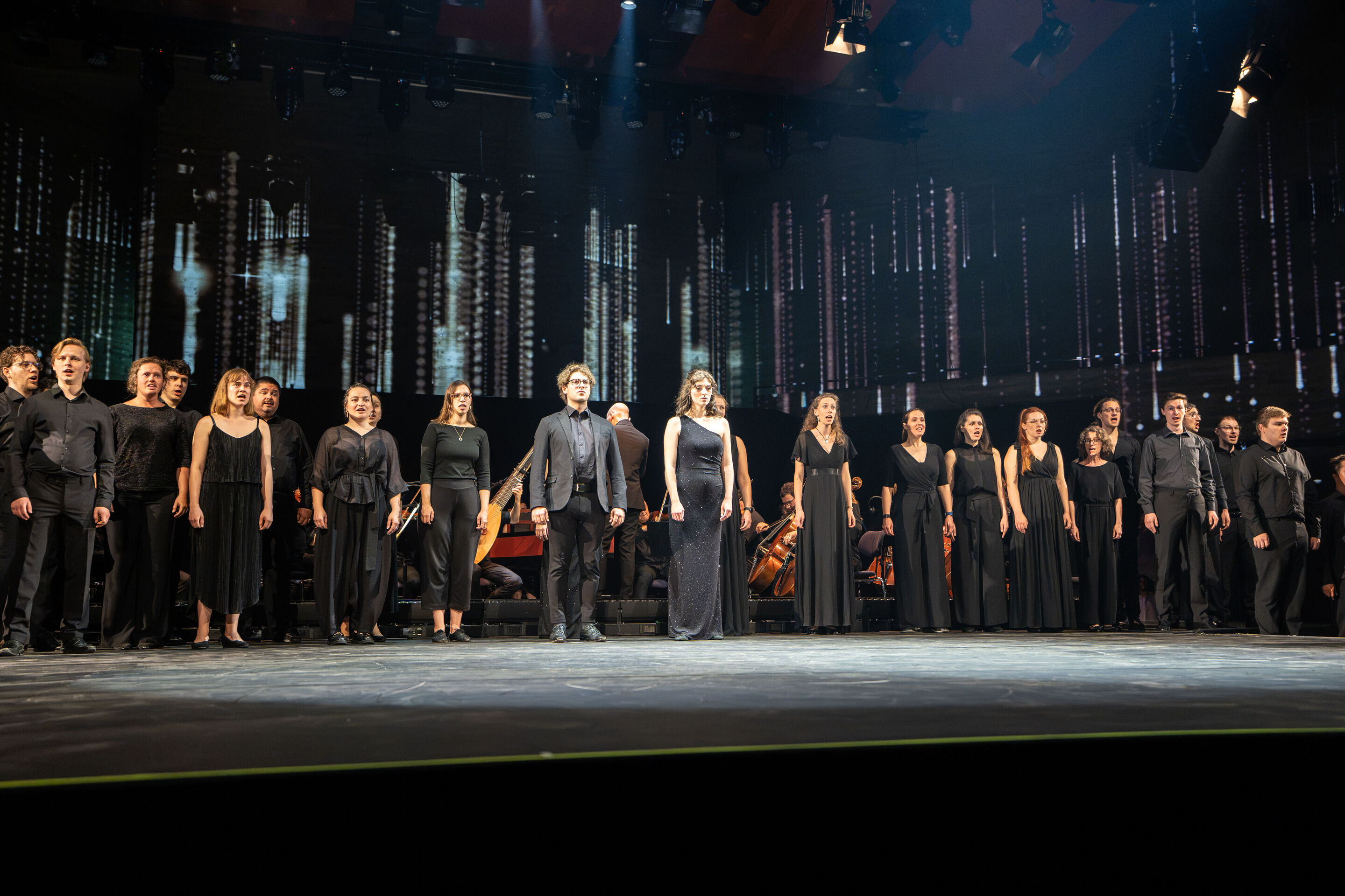 Audi Summer concert: Performance of “Dido and Aeneas” featuring Flying Steps at the Festsaal Ingolstadt - View of the stage in the Festsaal of the Stadttheater Ingolstadt, featuring the singers of the vocal ensemble LauschWerk dressed in dark concert...