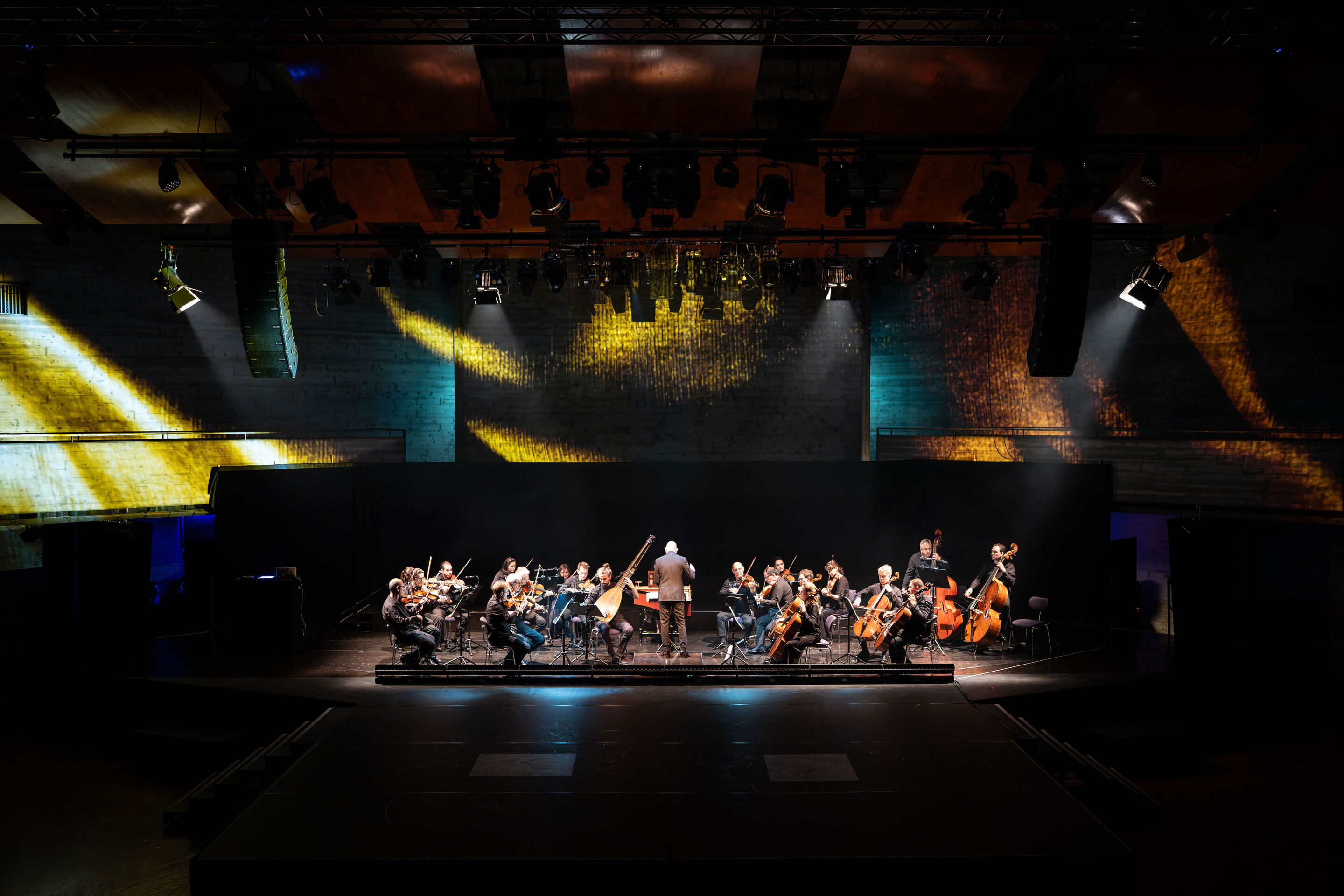 Audi Summer concert: Performance of “Dido and Aeneas” featuring Flying Steps at the Festsaal Ingolstadt - View of the stage in the Festsaal of the Stadttheater Ingolstadt, illuminated by warm spotlighting. The Kammerphilharmonie Ingolstadt is performing,...