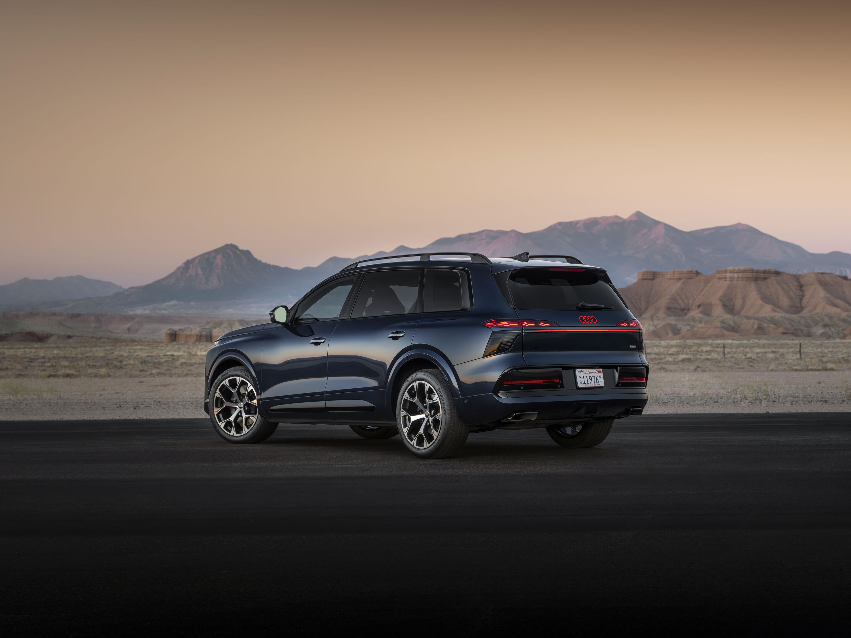 Audi Q9 SUV - Waitomo blue metallic, outdoor static photo, exterior, three-quarter rear view