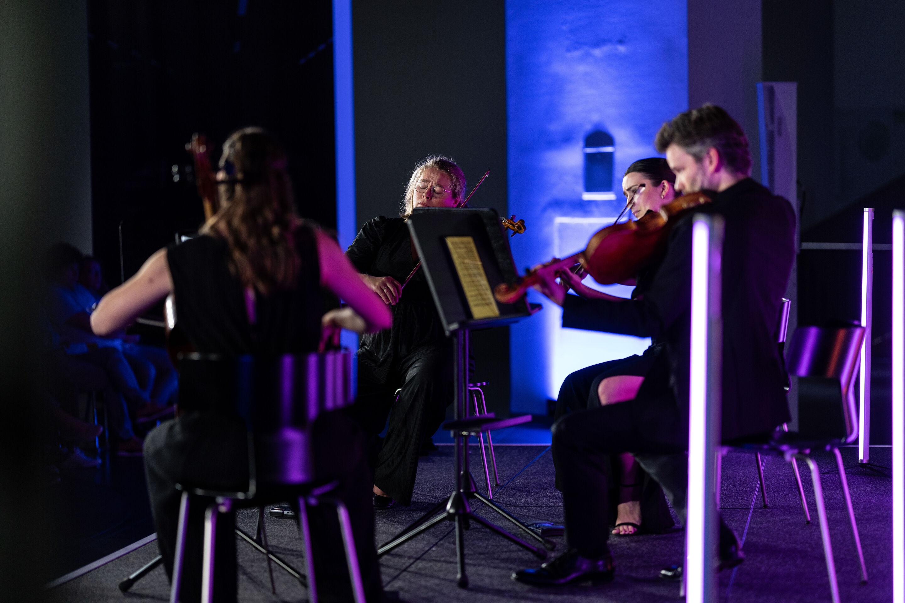 Audi Summer concert: Barbican Quartet at Audi museum mobile - The members of the Barbican Quartet perform on stage at the museum mobile of the Audi Forum Ingolstadt. The four ensemble members are seated around centrally positioned music stands, playing...
