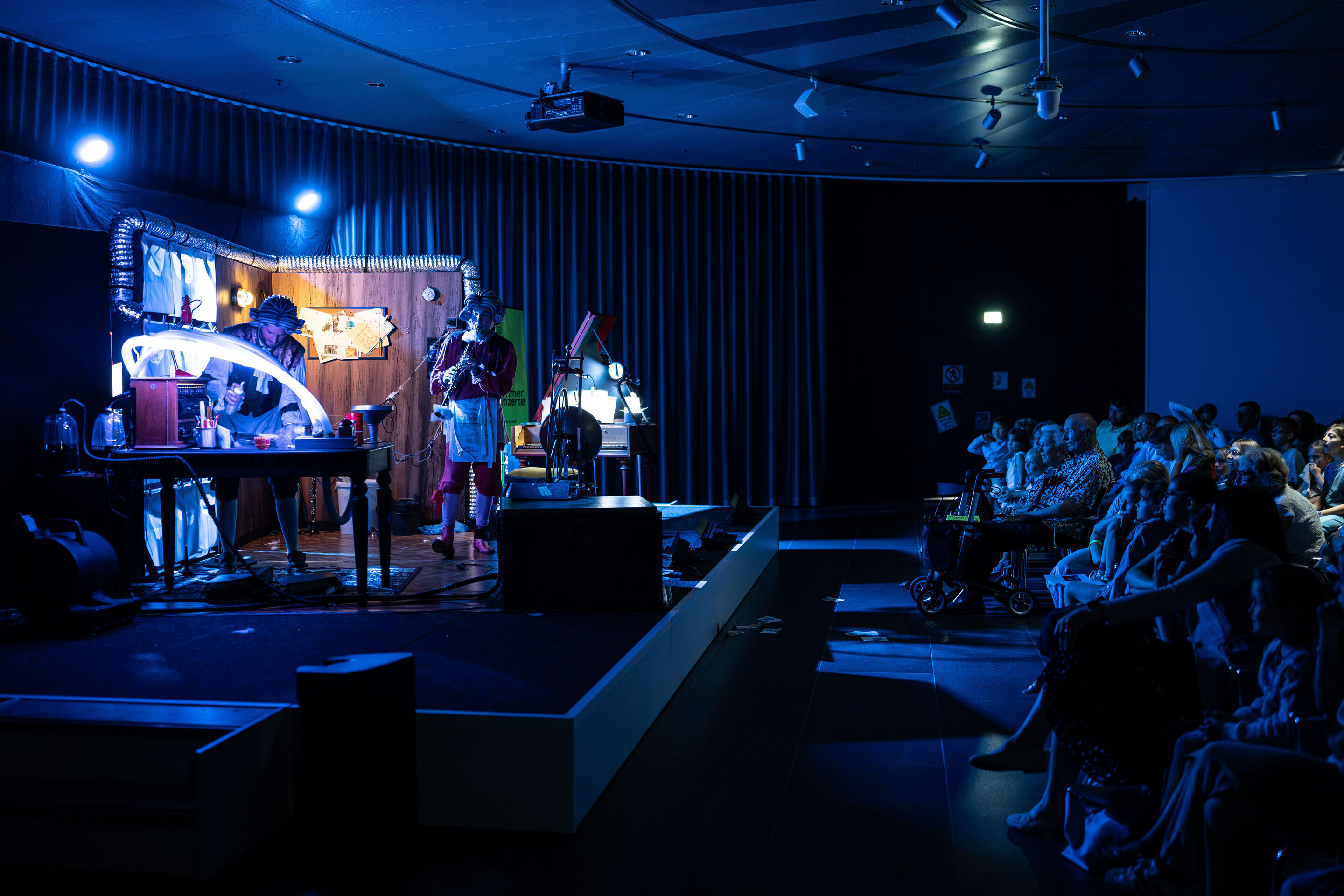 Scene from the children’s opera “Holle!” (The Salzburg Festival as a guest at the Audi Summer Concerts) - Side view of the stage and audience during the children's opera Holle! at the museum mobile of the Audi Forum Ingolstadt. On the left, Tatiana Kuryatnikova...