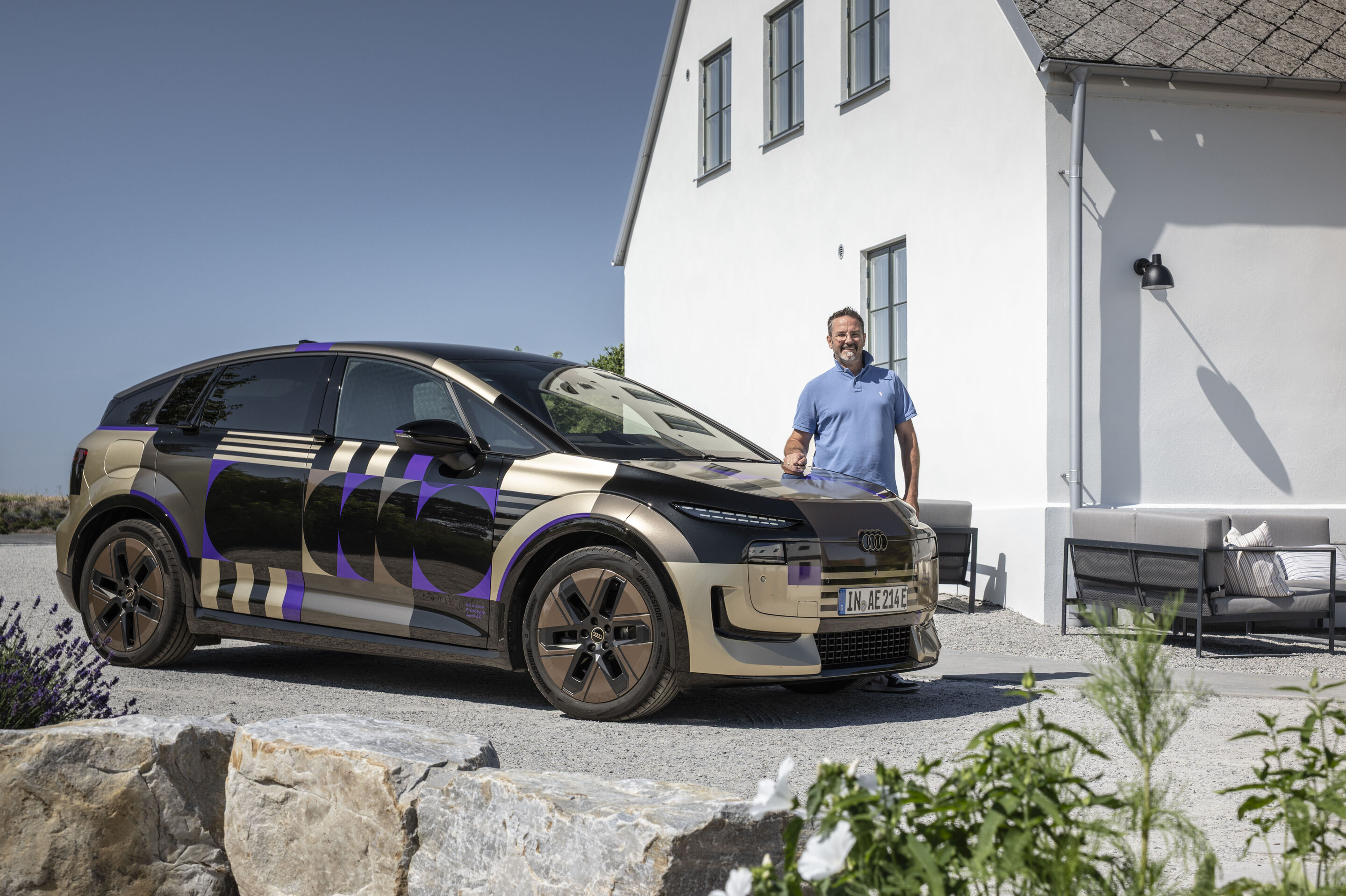 Dr. Benedikt Hackl at the Audi A2 e-tron with design livery - Energy Systems Project Manager for the Audi MEB model series, stands in front of an Audi A2 e-tron with design livery.