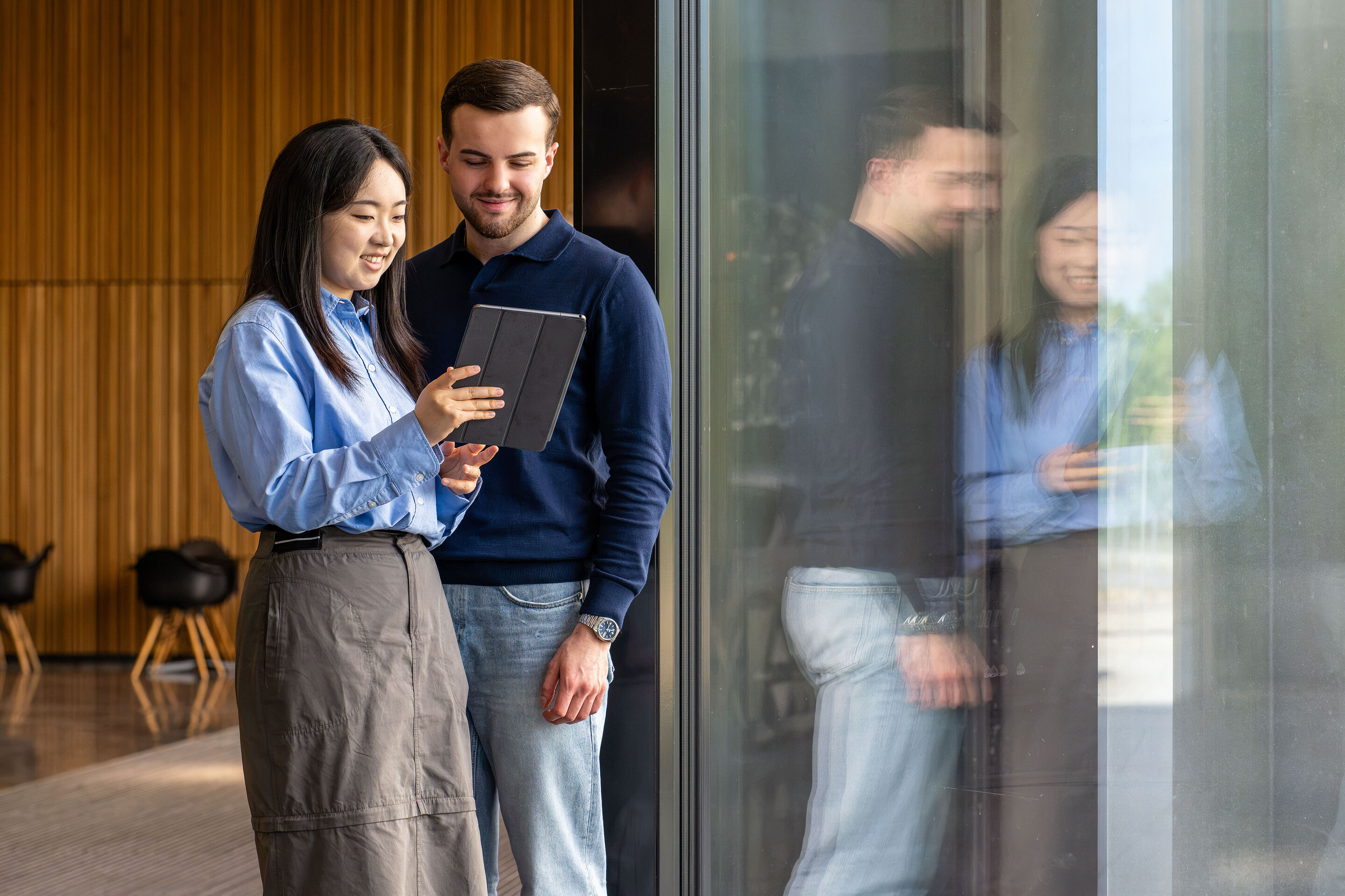 Two students standing and talking - Two students standing and talking