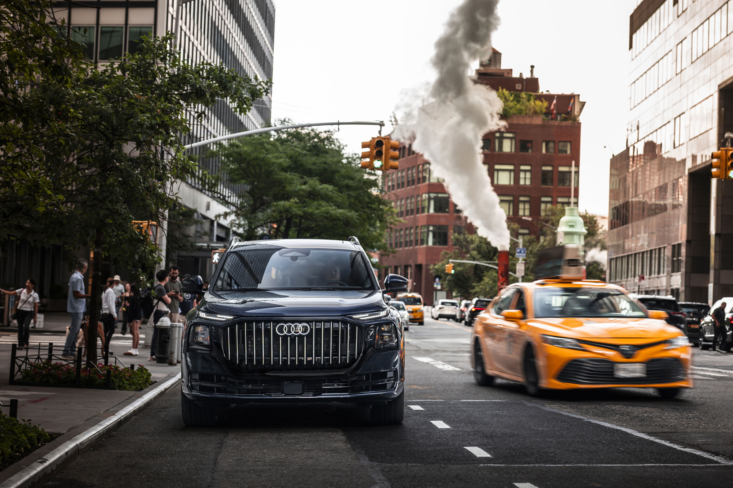 Audi Q9 SUV - Audi Q9 SUV — Waitomo blue metallic, dynamic photo in New York City. The image shows a US-specification model.