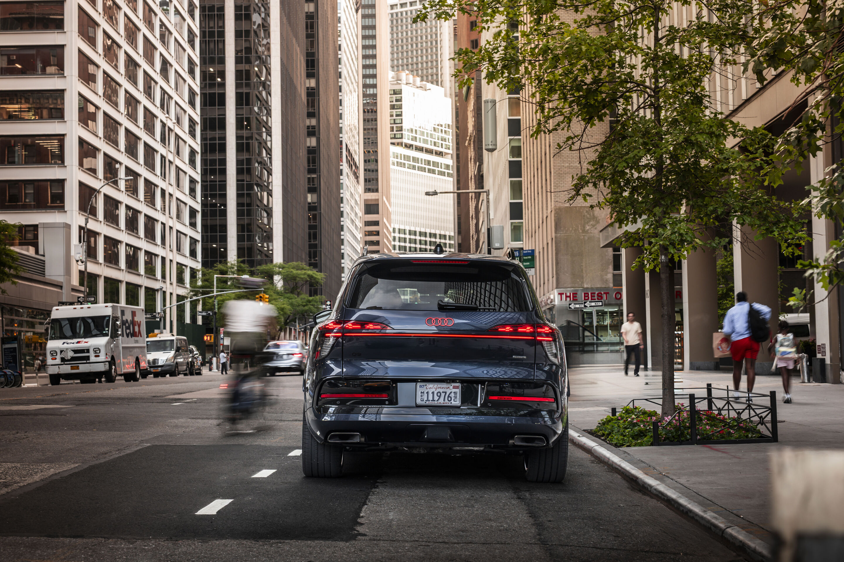 Audi Q9 SUV - Audi Q9 SUV — Waitomo blue metallic, dynamic photo in New York City. The image shows a US-specification model.