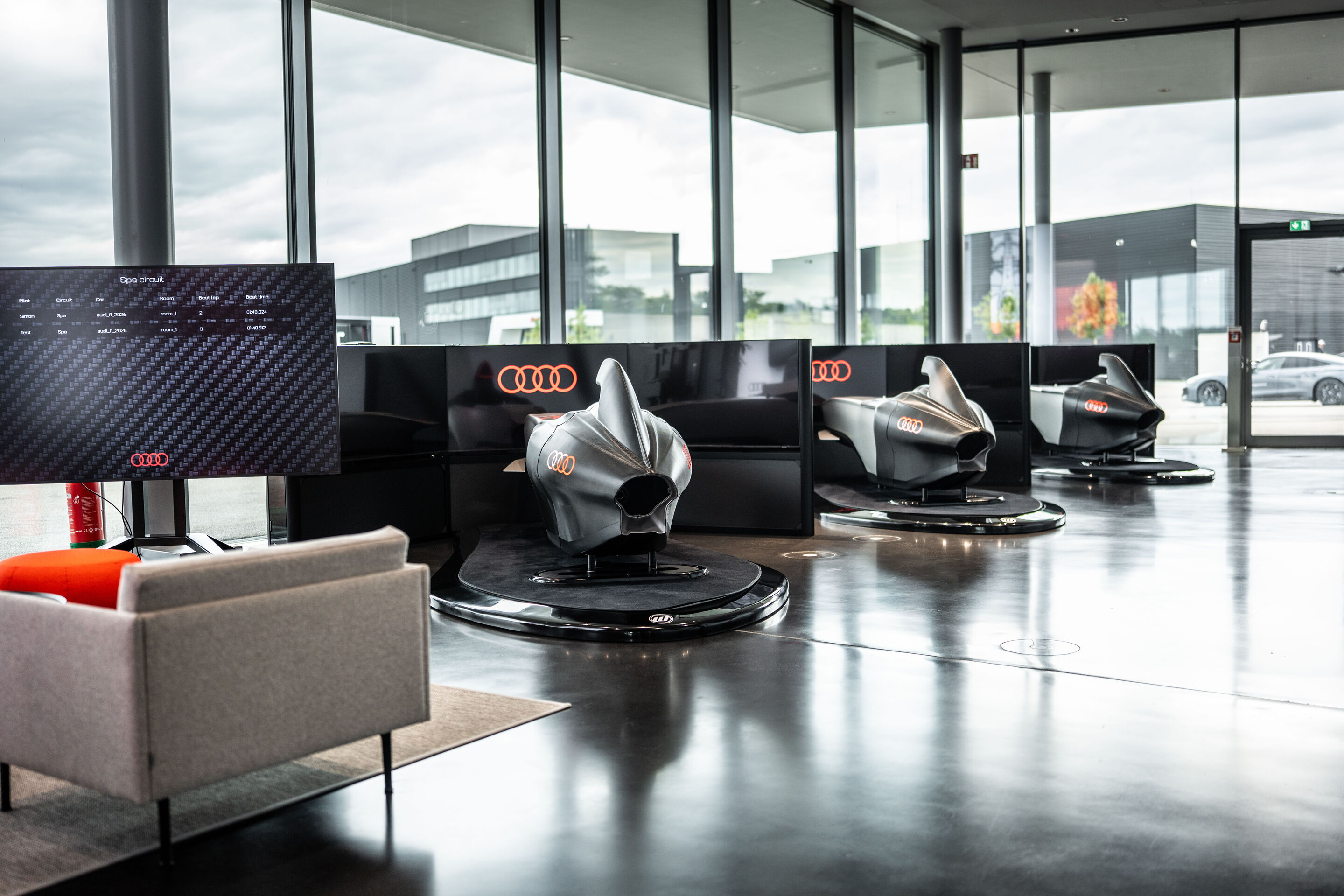 Audi racing simulators - The Audi racing simulators at the Audi driving experience center in Neuburg combine an authentic, physical Formula-style cockpit with highly developed simulation technology.