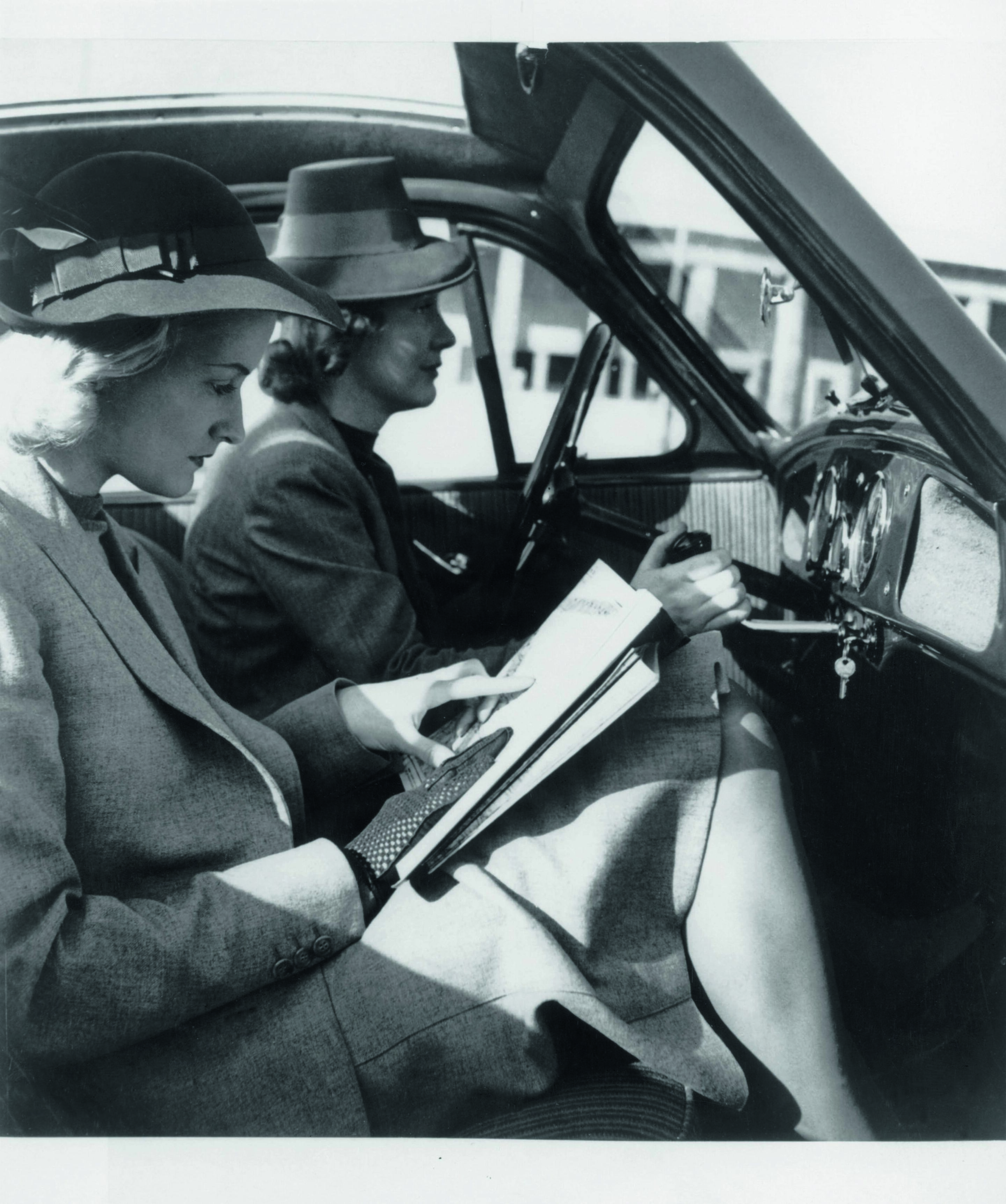 Anniversary magazine History - DKW - two young ladies pose in the prototype DKW F9 from 1940